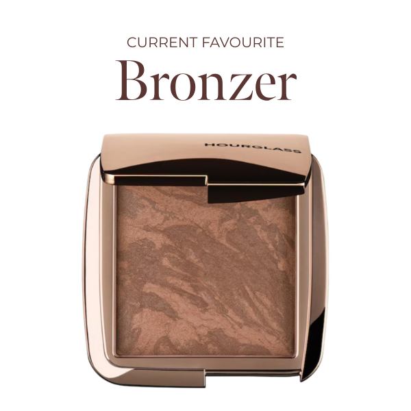 A bronzer makeup compact with a marbled brown powder inside, placed against a white background. The packaging is sleek and reflective, and the text indicates it is a favorite bronzer.