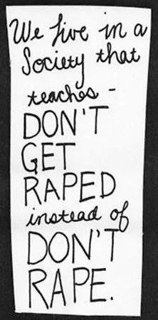 A poster reading "We live in a society that teaches DON'T GET RAPED instead of DON'T RAPE.