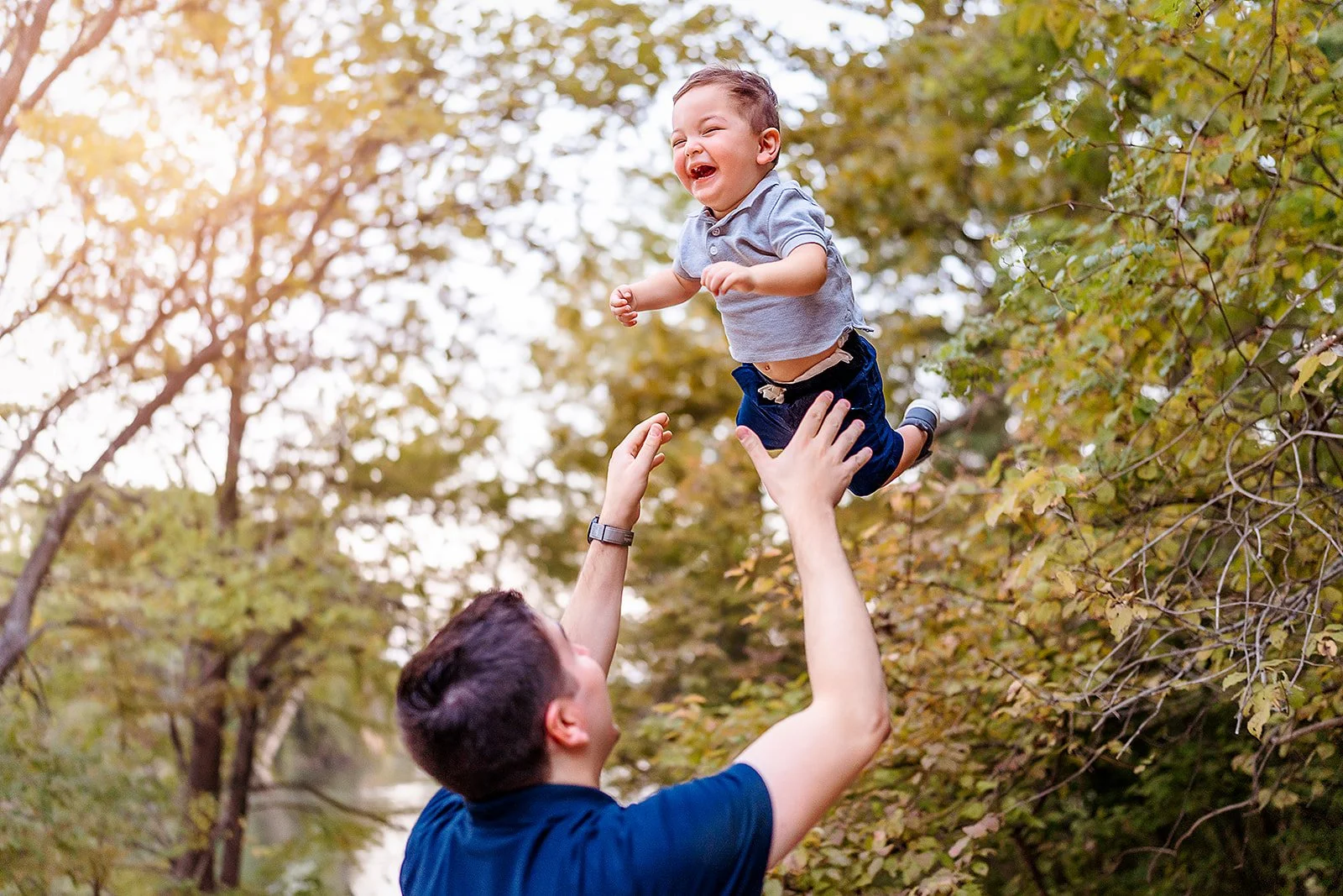 father and son playing family photos at Red Bud Isle in Austin