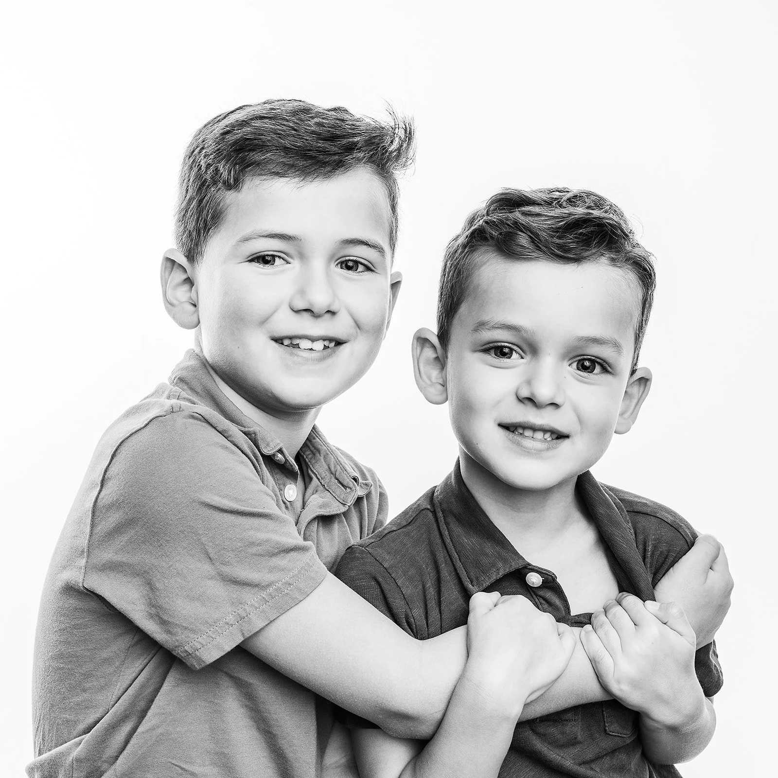 Black and white portrait of siblings playing together in Austin