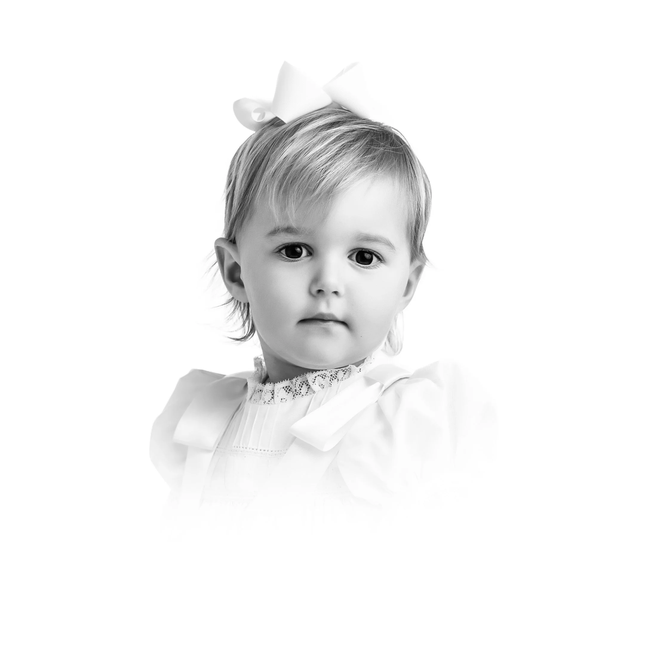 A timeless heirloom portrait of a charming toddler girl with a bow, captured in a classic vignette style in Austin, Texas.