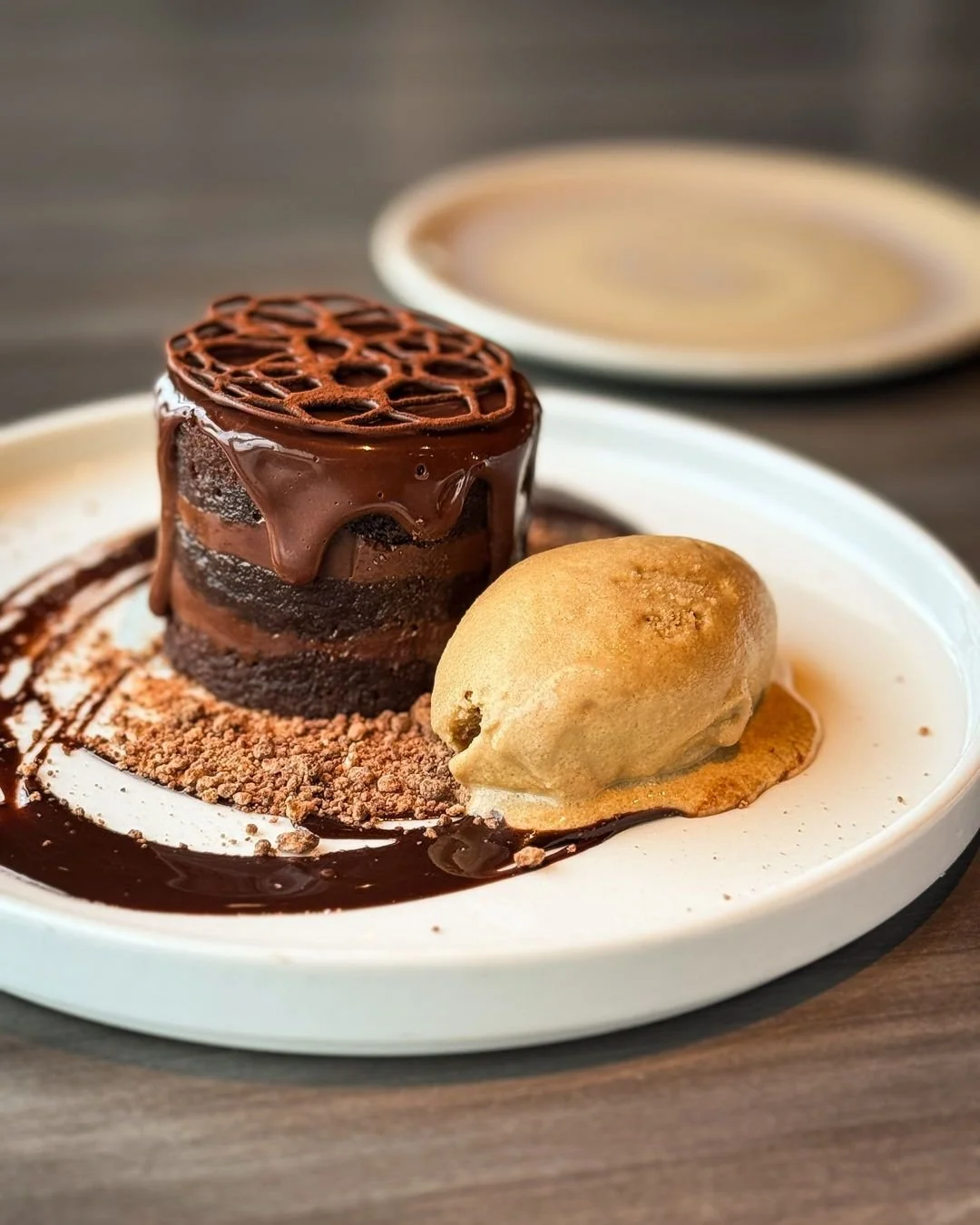 All the chocolate, none of the regrets🍫 

CHOCOLATE GANACHE CAKE
Creamy ganache, chocolate cake, crystallized chocolate, and espresso ice cream