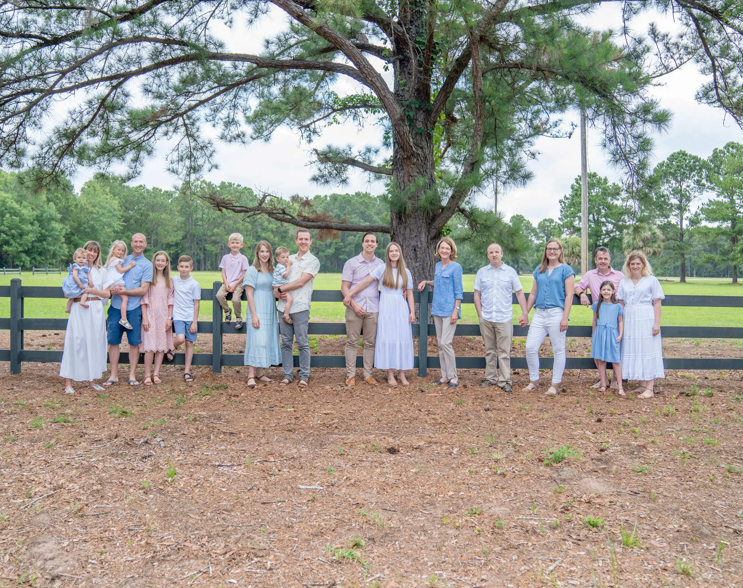 Large family standing in front of a fence for a Hilton Head family photographers