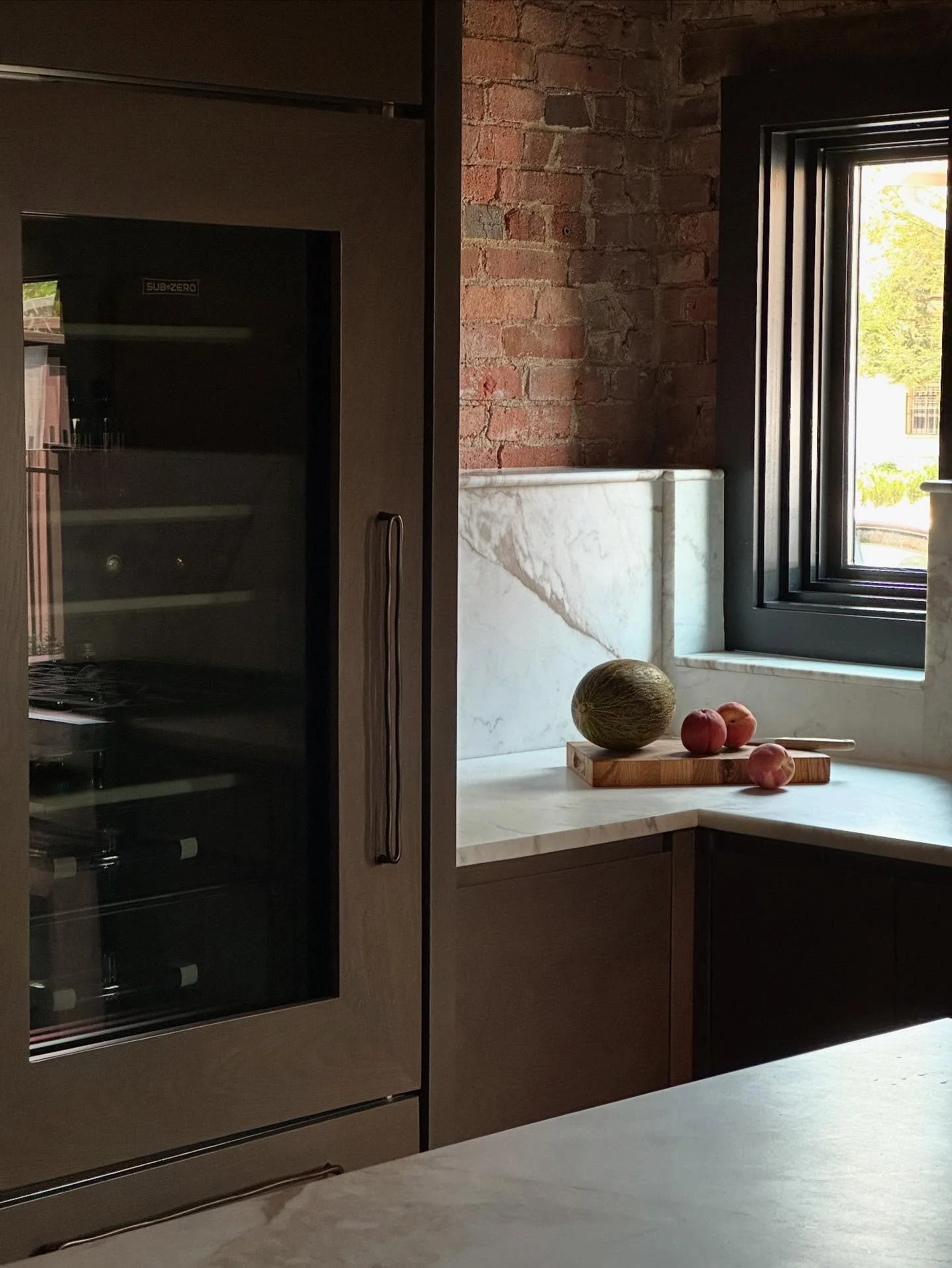 ✖️details are felt in the pause between textures and materials. Early 1900s brick, marble and white oak create nice weight and warmth in our show house kitchen. I love this vignette of Santa Claus melon and late summer peaches. But I&rsquo;m ready fo