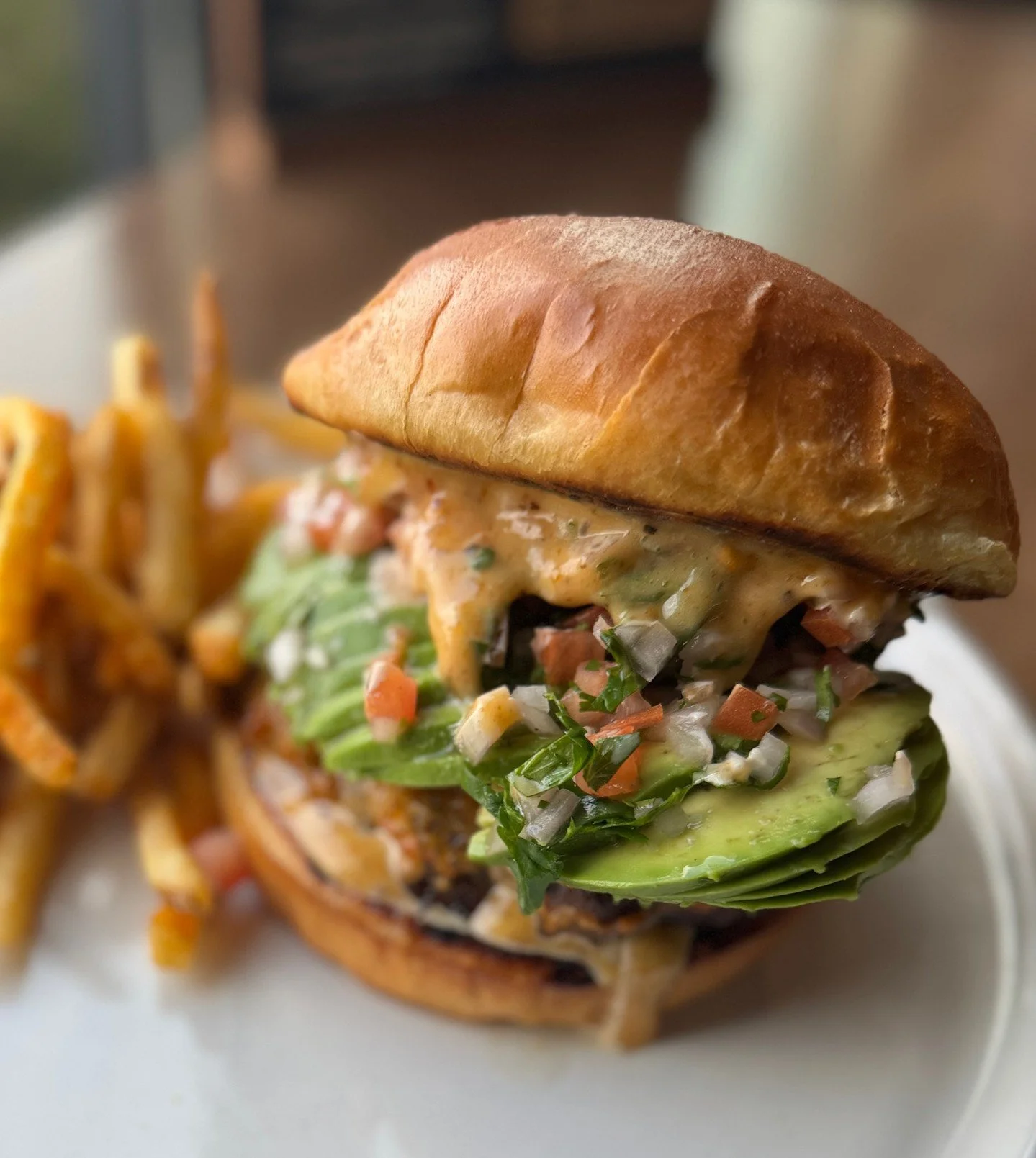 Our  Burger of the Month came to make a statement. 🍔

An 8oz Angus beef patty cooked to order, stacked with cheddar, pico de gallo, avocado, and chili crunch aioli on a brioche bun.