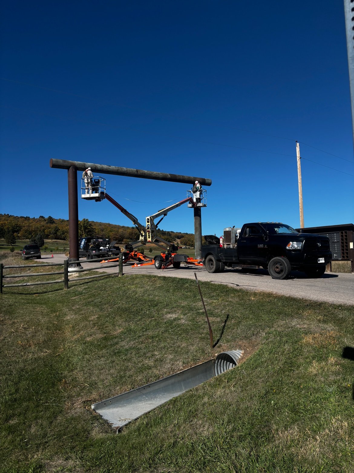 Crew in lifts setting pipe entrance posts at Frawley Ranch