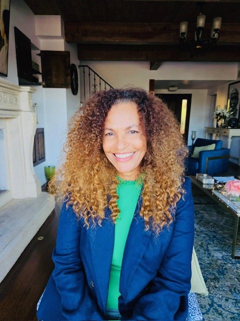 Monique Mannen smiling at home, sharing her journey to better health, cellular wellness, and healthy aging.