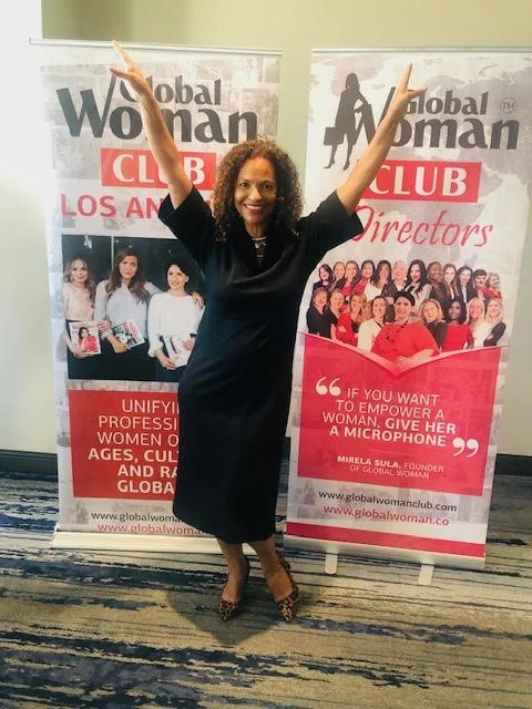 Monique Mannen speaking at a Global Woman Club event, inspiring women through leadership, wellness, and personal growth.