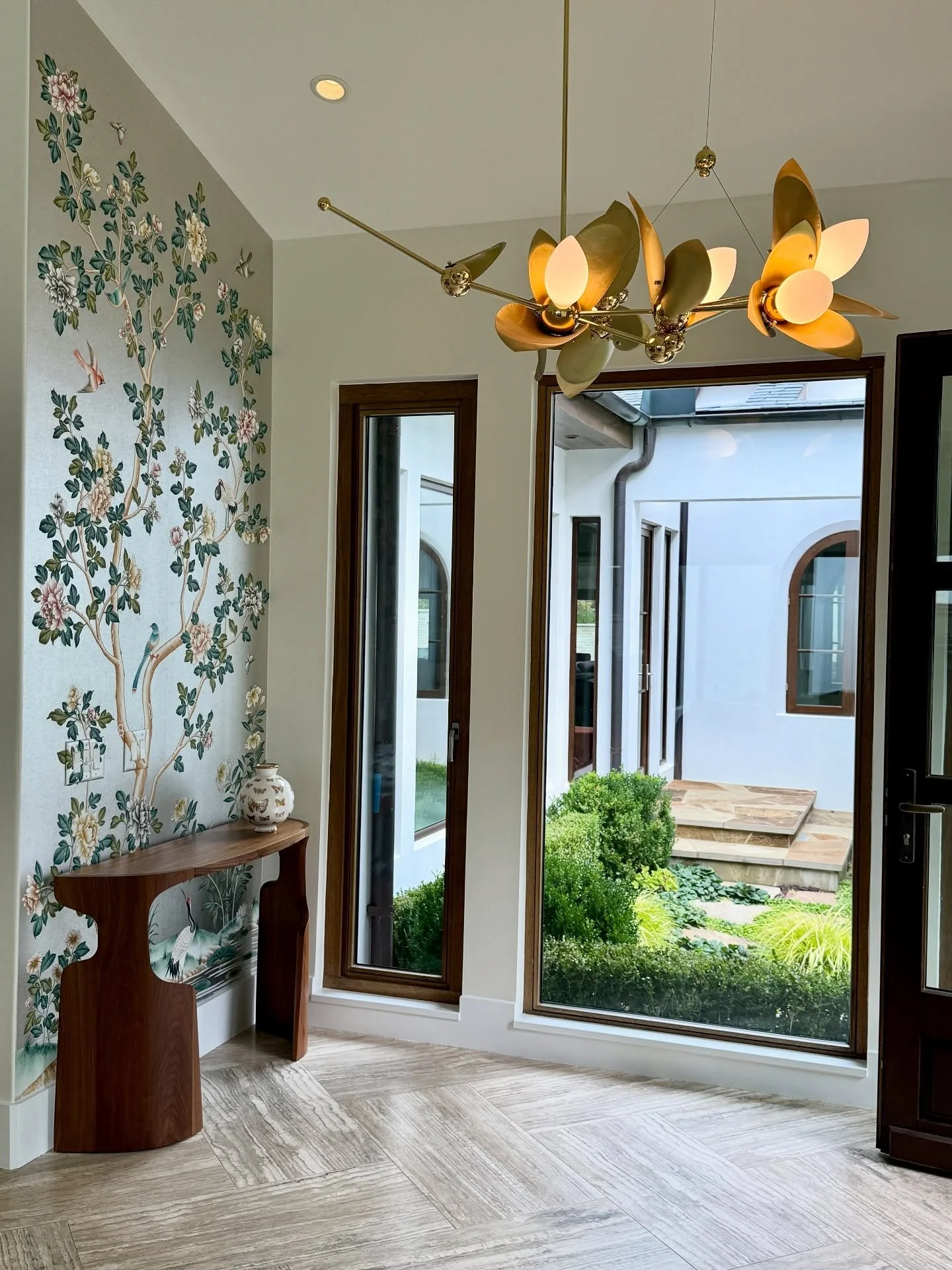 Thrilled to see this custom @graciestudio wallcovering gorgeously gracing 😉 the foyer and living room walls at our client&rsquo;s Buckhead home. What a beautiful way to enter the weekend. (And that @rosielistudio laurel blossom chandelier&hellip; no
