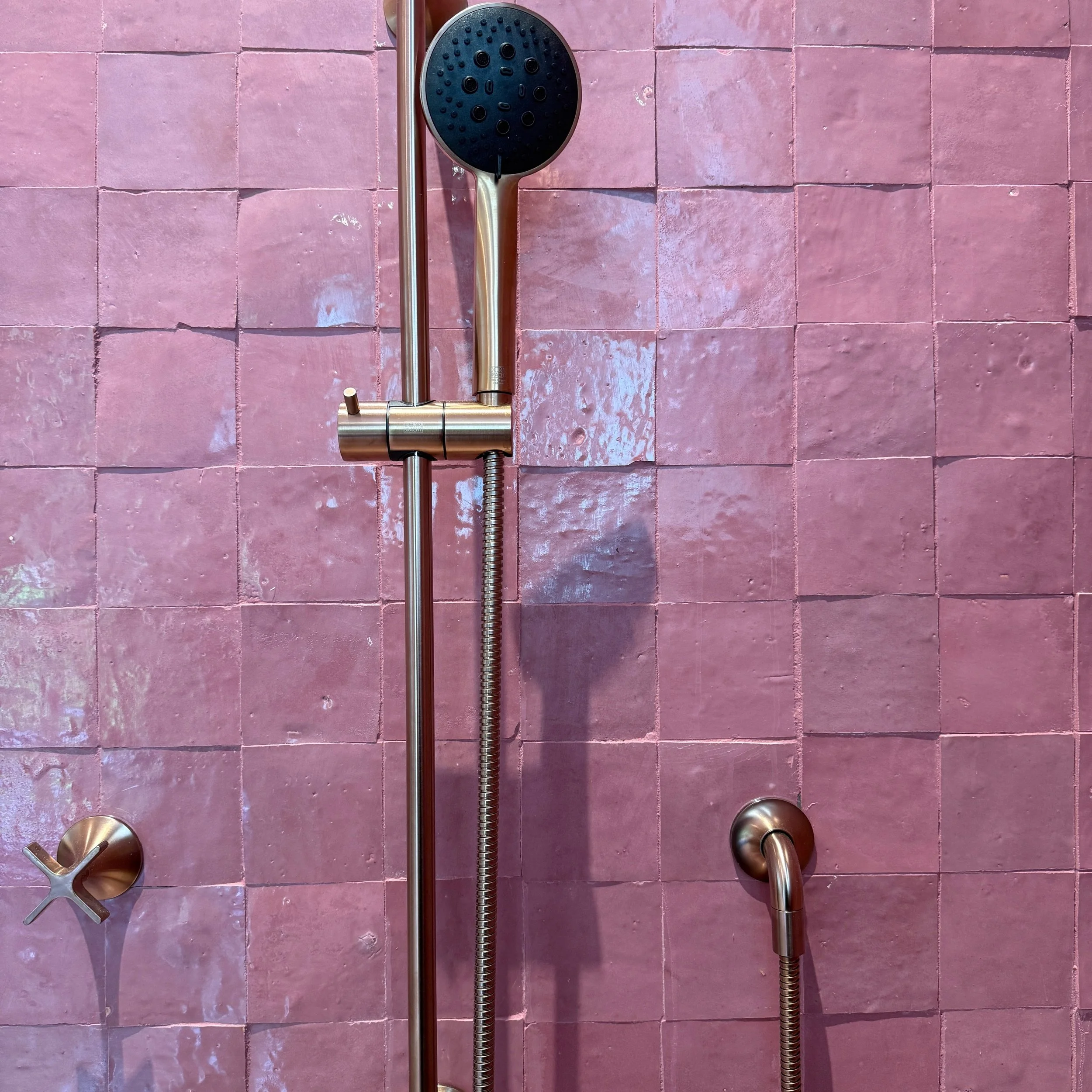 I cannot quit that Pantone-match grout, and the @dornbracht_official bronzed brass 💋. #custominteriors #bathroomdesign #attentiontodetail #pinkbathroom #cginteriorsgroup