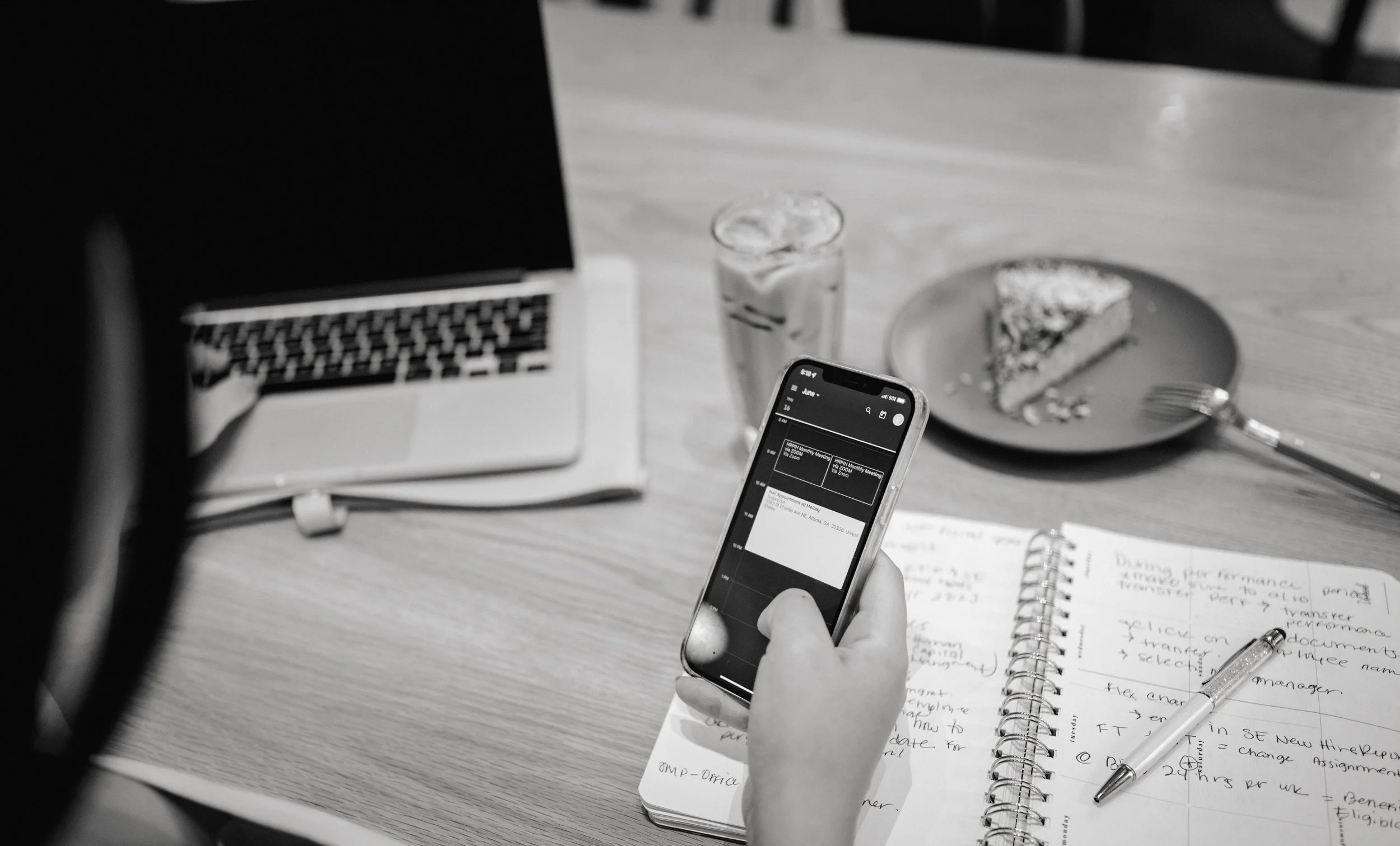 Frances Castillo reviewing people operations details on a phone and notebook.