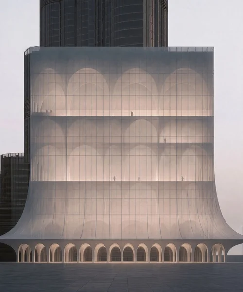 M15 · Árdh, concept image — a translucent white tower of stacked arched vaults, flared at the base over an arcade, beside a dark high-rise