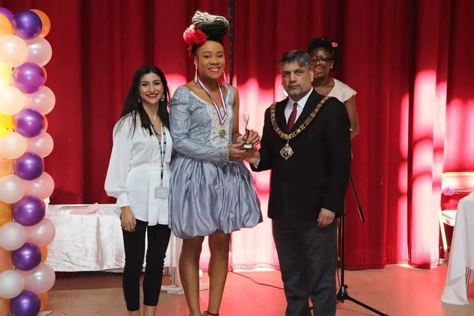 Lady of the Ceremony (Chidera Audi). She received a Trophy for being the best lady in our tailoring class (2019 group). The dress she is wearing was made by her after her training period with us. Chidera came to Skilled  Hands with little or no  know