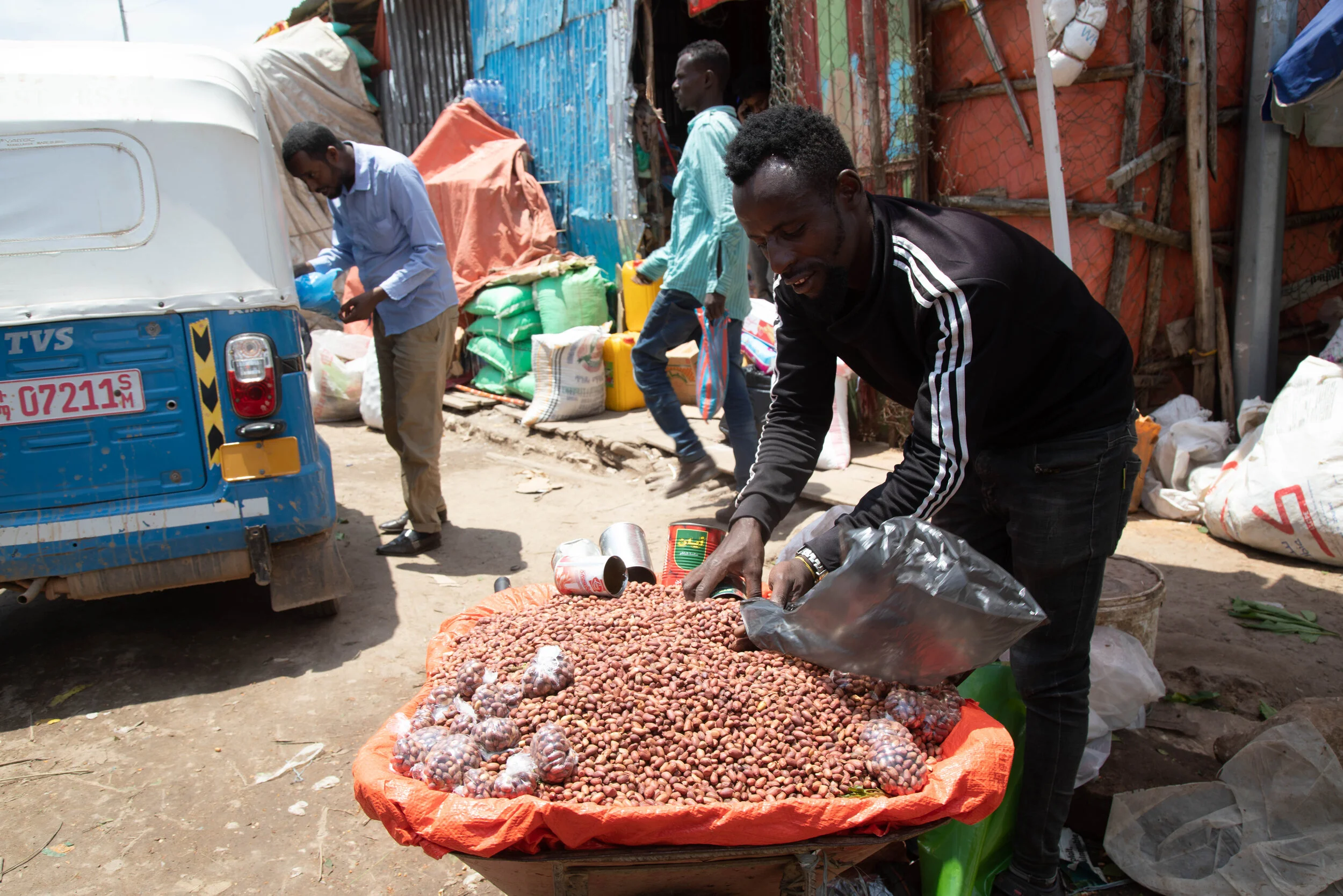  A roadside groundnuts vendor weighing nuts for his customers.