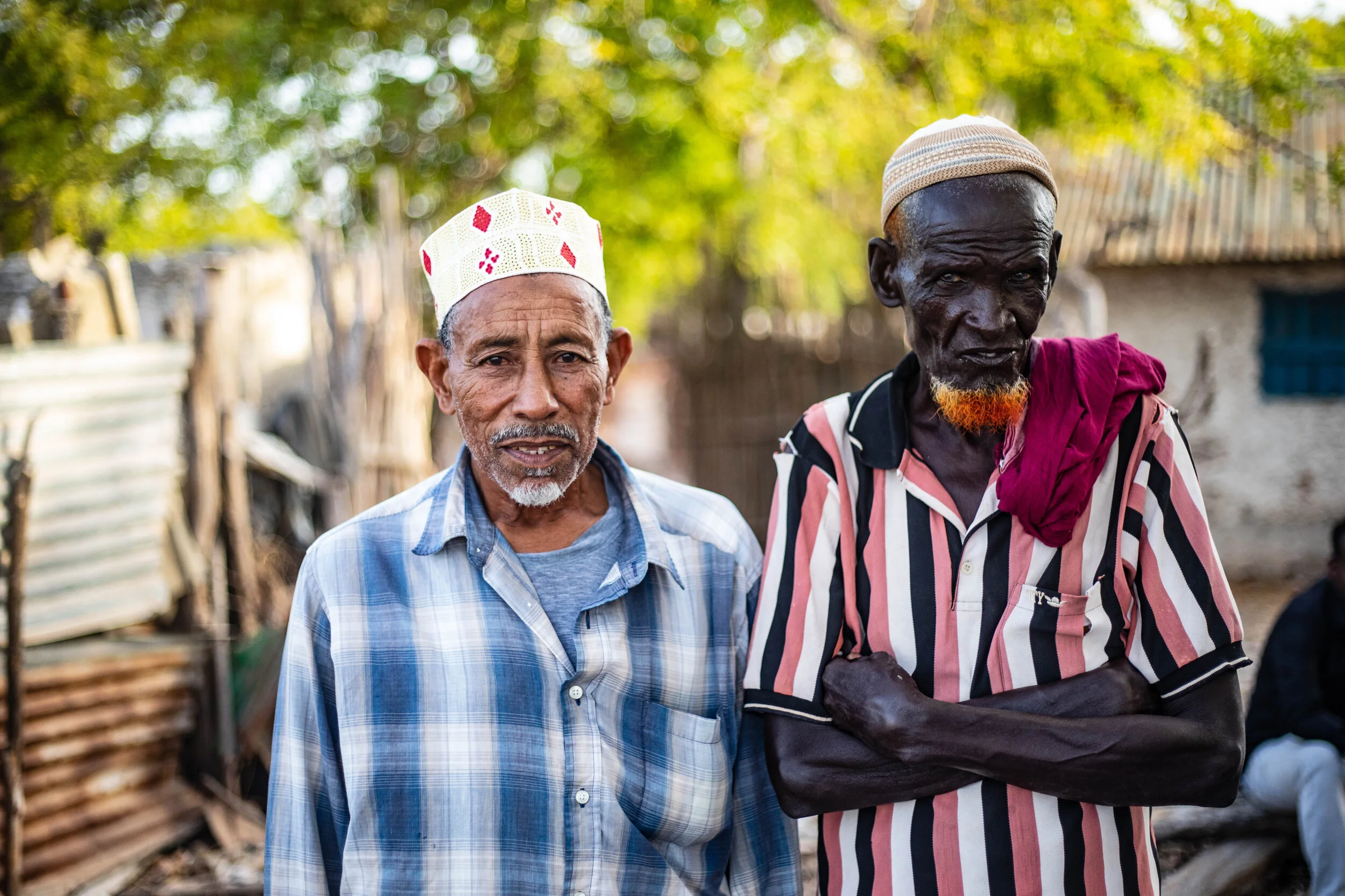 Mohamed Omar, 64, (left) and Kassim Mursal, 70, (right), childhood friends who have lived in Kuday, Somalia, for decades. The two men have maintained a close friendship since childhood.