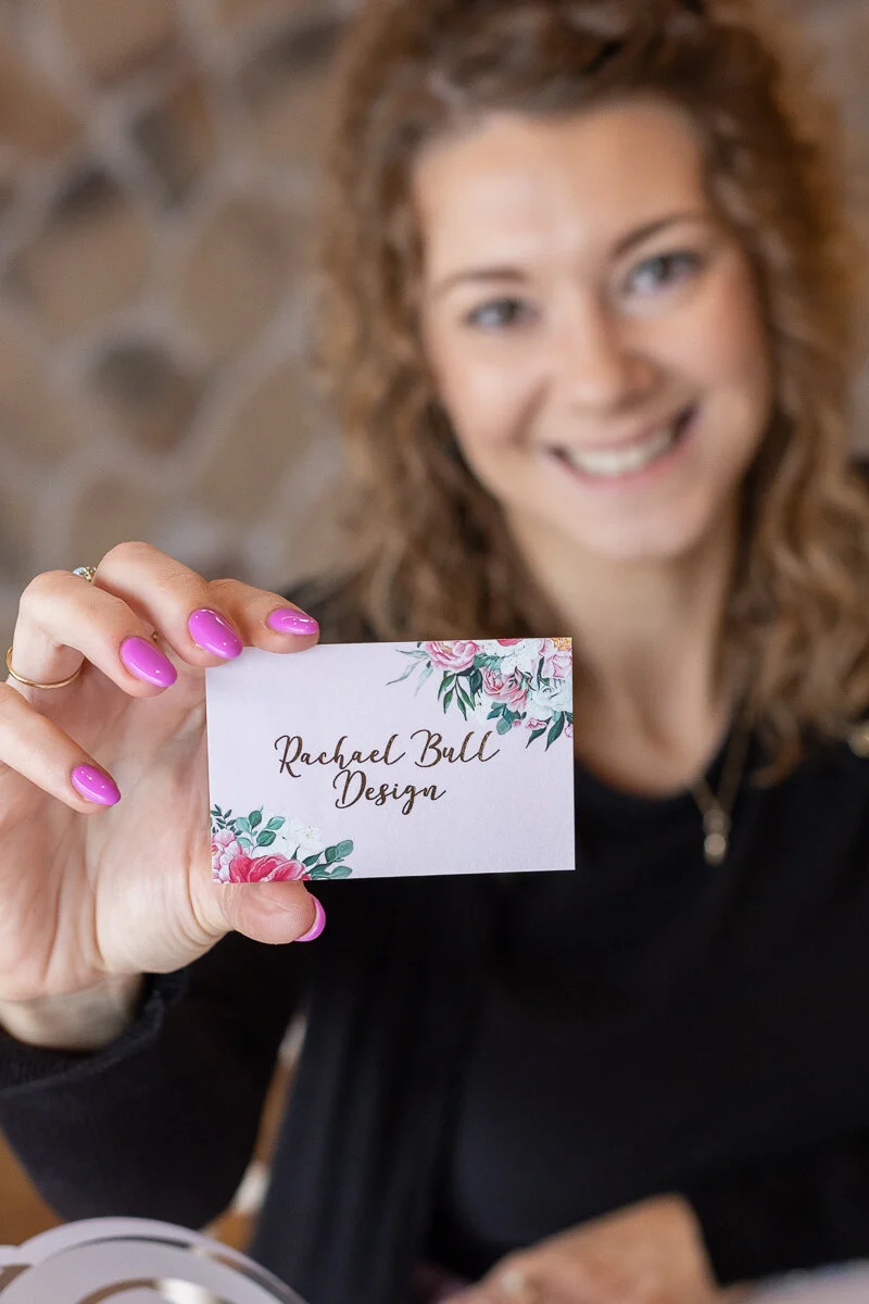 Rachael Bull Designs holding her business card for her Norfolk business of Wedding stationery
