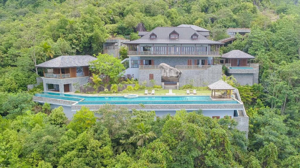 Aerial view of Villa Salazie and its infinity pool surrounded by tropical forest in Seychelles.