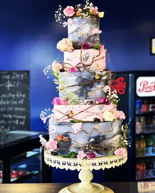 Various loaves of bread balancing on each other.