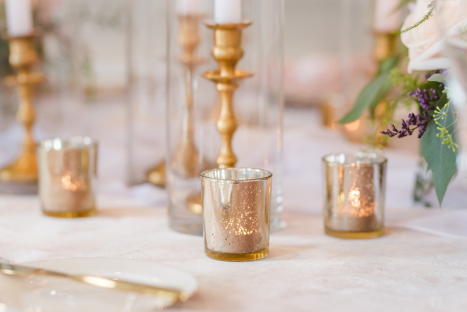 Wedding reception decor of gold candles and blush napkins for the tablescape wedding at the Don Cesar.jpg