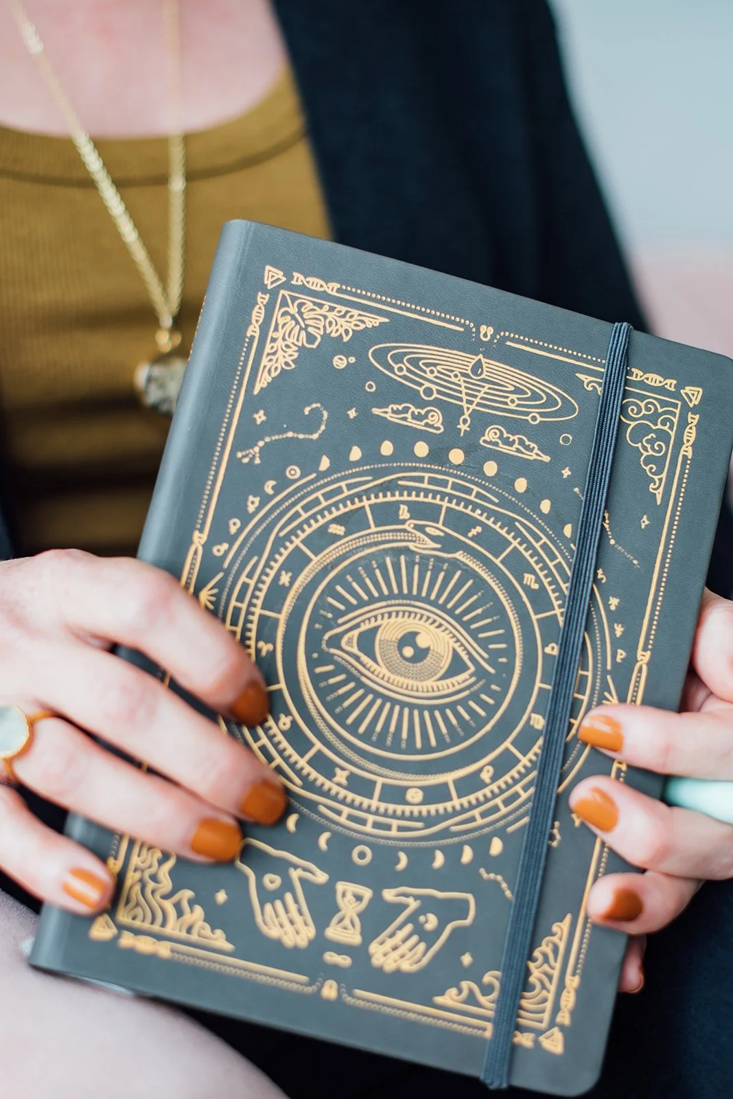 Julie Ciecior, a female therapist in Boulder, CO, holding a journal for a mediumship therapy for women and other therapists.