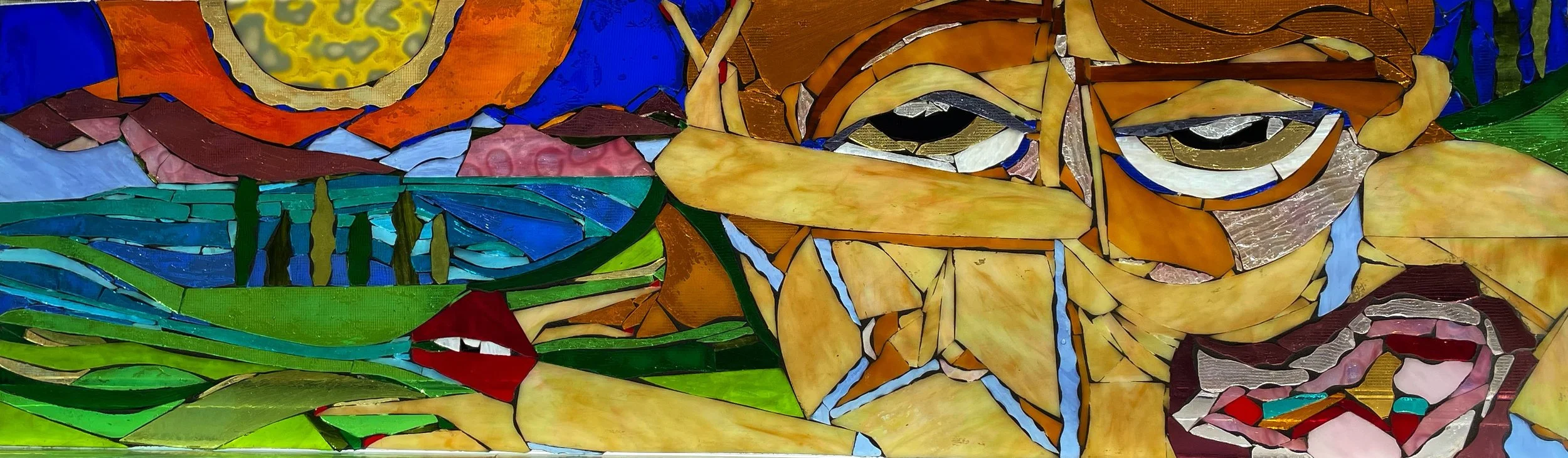 A colorful stained glass mosaic depicting a tiger resting near a pond with trees and a mountain in the background.