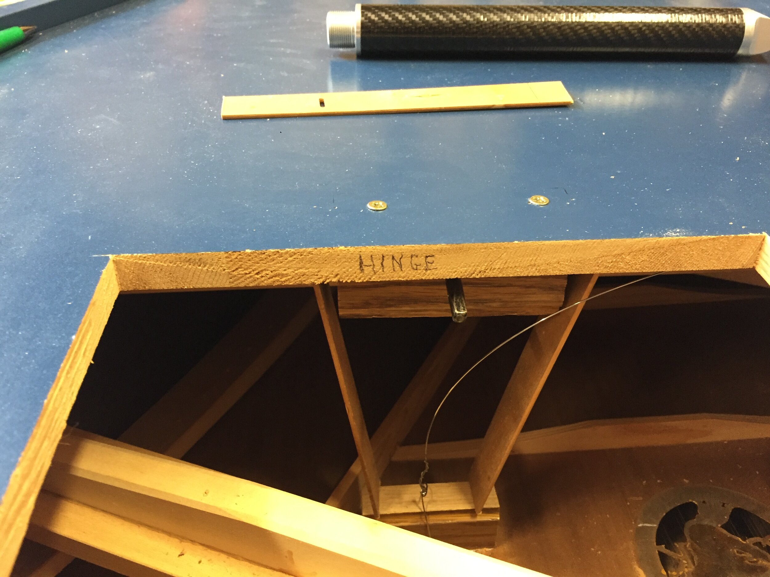 Here we are gluing a wooden block to install a wire to pull down the warped soundboard with a wire, using the a tuning pin