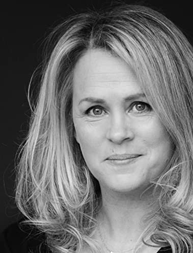 Black and white portrait of a woman with shoulder-length blonde hair and a subtle smile.