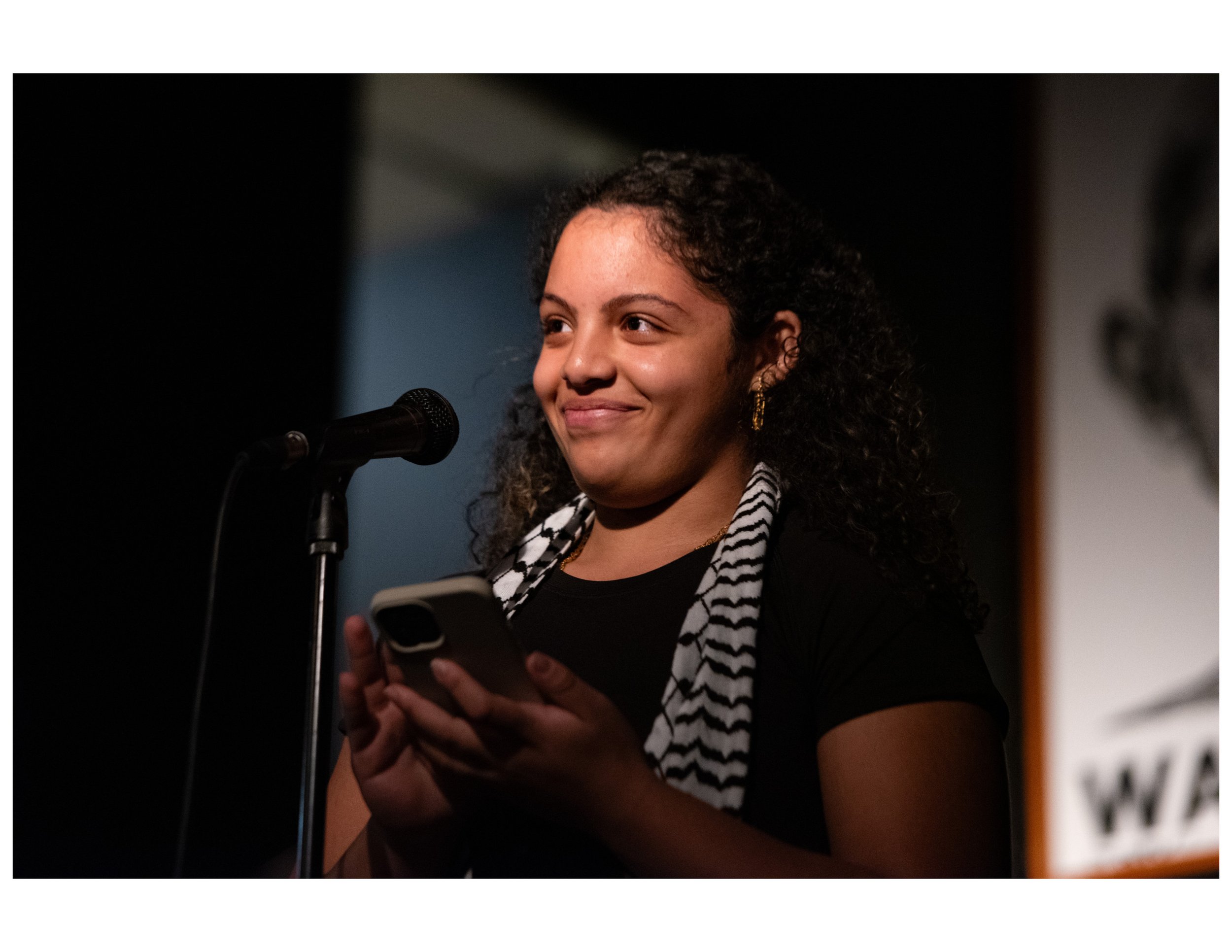   Youth Poet Laila performs original poem at an open mic event hosted by Words Beats &amp; Life Inc. at Busboys and Poets in Washington, DC. Photographer/Victoria Ford  