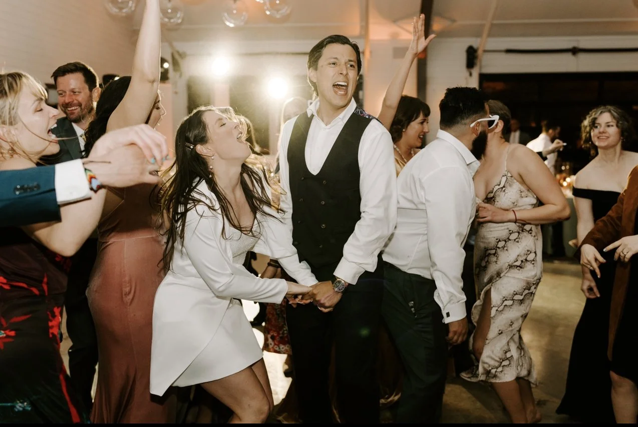 People dancing, singing, and celebrating at a lively event or party.