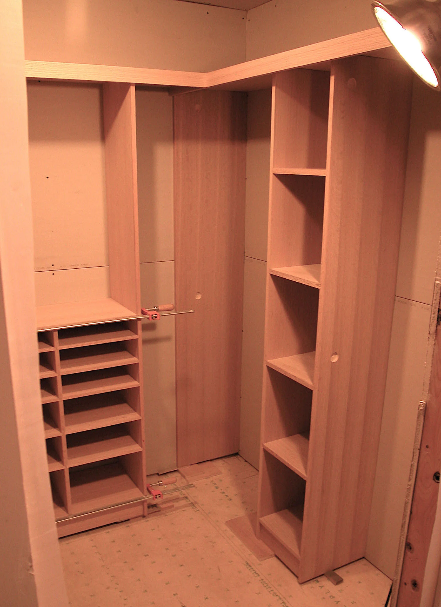 test fit of walk in closet custom designed storage solution before staining quarter sawn oak