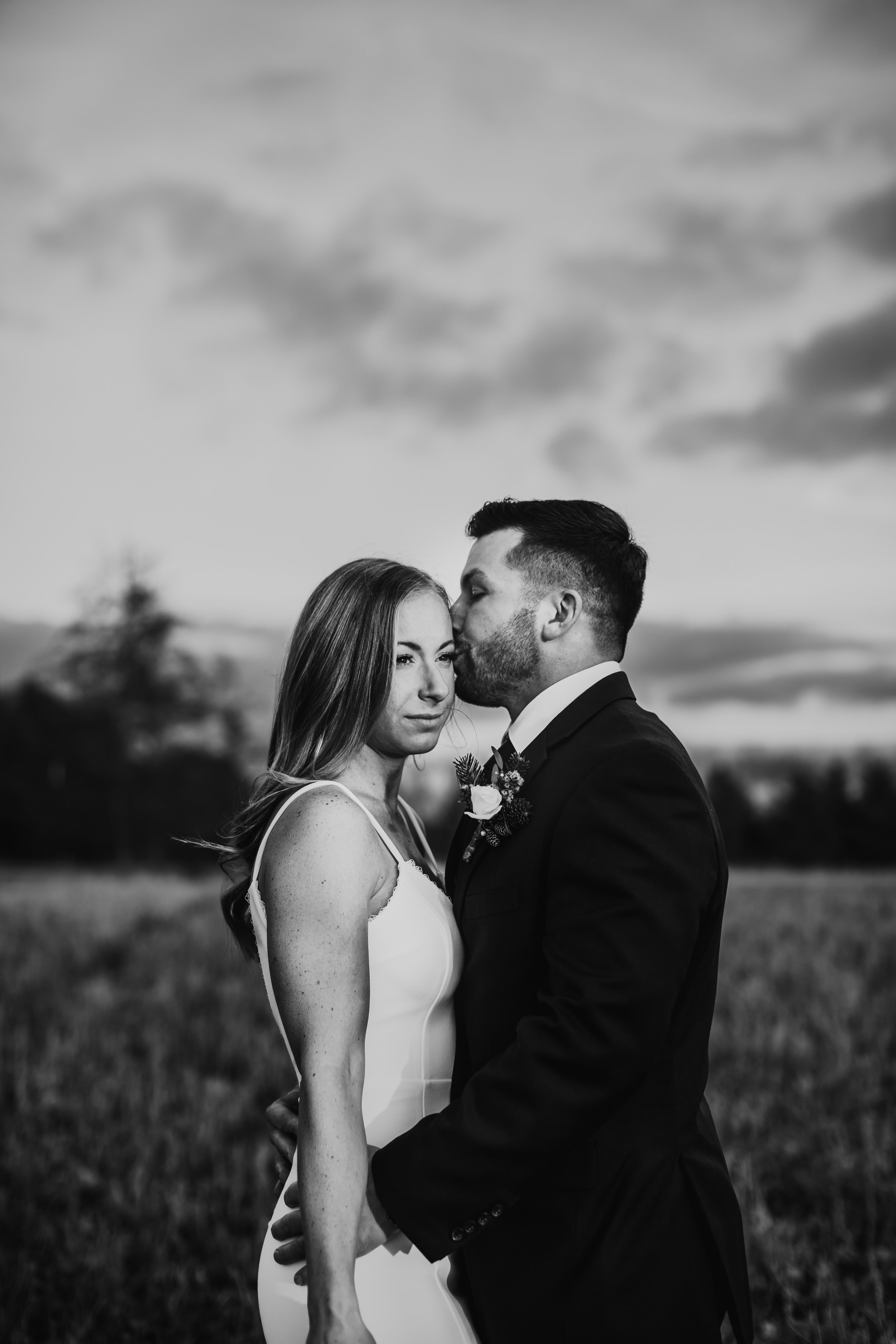  A Black and white portrait of a groom kissing the bride's head was captured by Teala Ward Photography in LaSalle. newlyweds she said yes #tealawardphotography #tealawardweddings #LaSalleIllinois #IronwoodontheVermillion #weddingphotographyIL 
