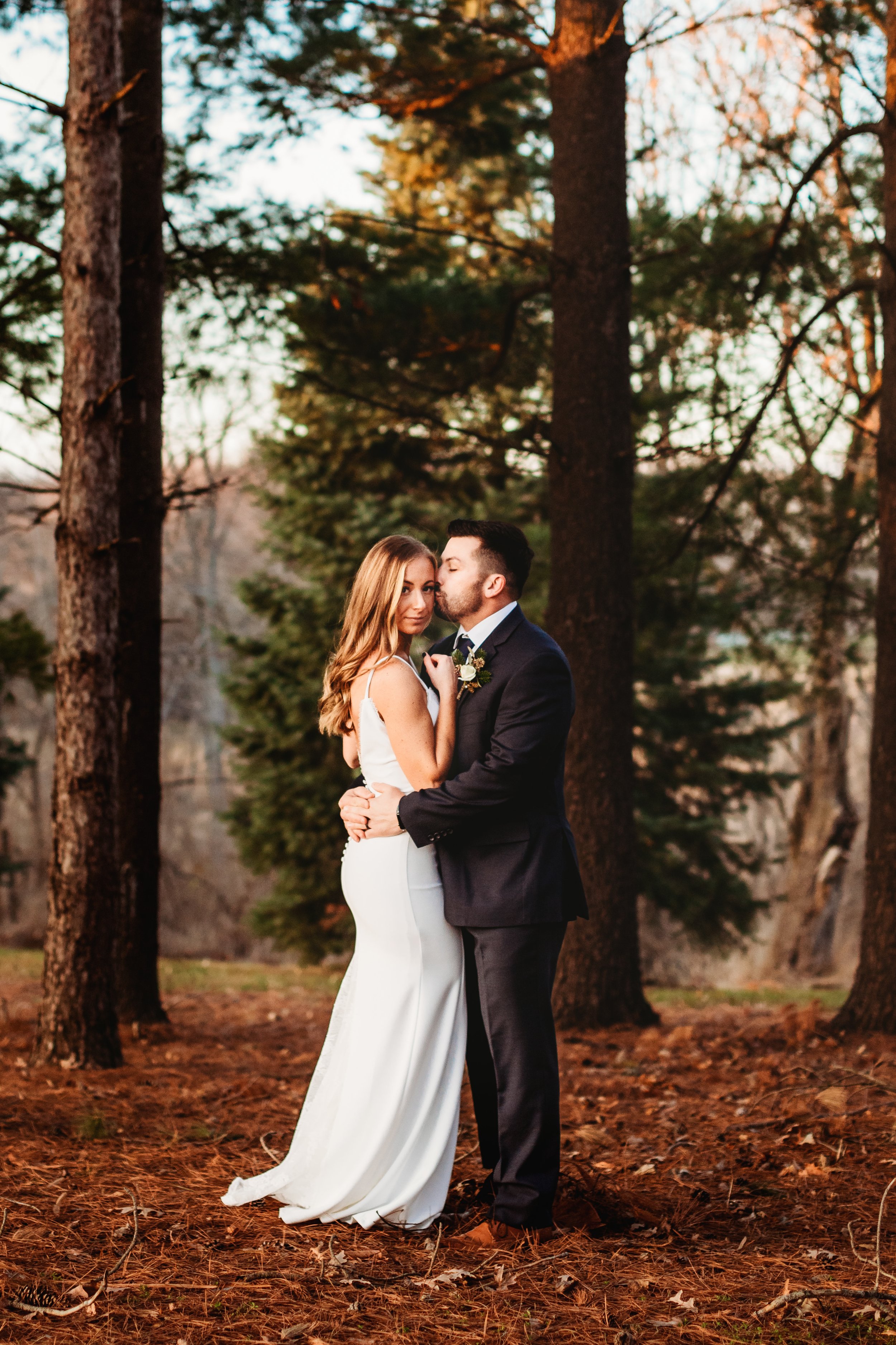  At the Ironwood on the Vermillion a bride and groom embrace on their wedding day at dusk by Teala Ward Photography. dusk wedding photo forest #tealawardphotography #tealawardweddings #LaSalleIllinois #IronwoodontheVermillion #weddingphotographyIL 