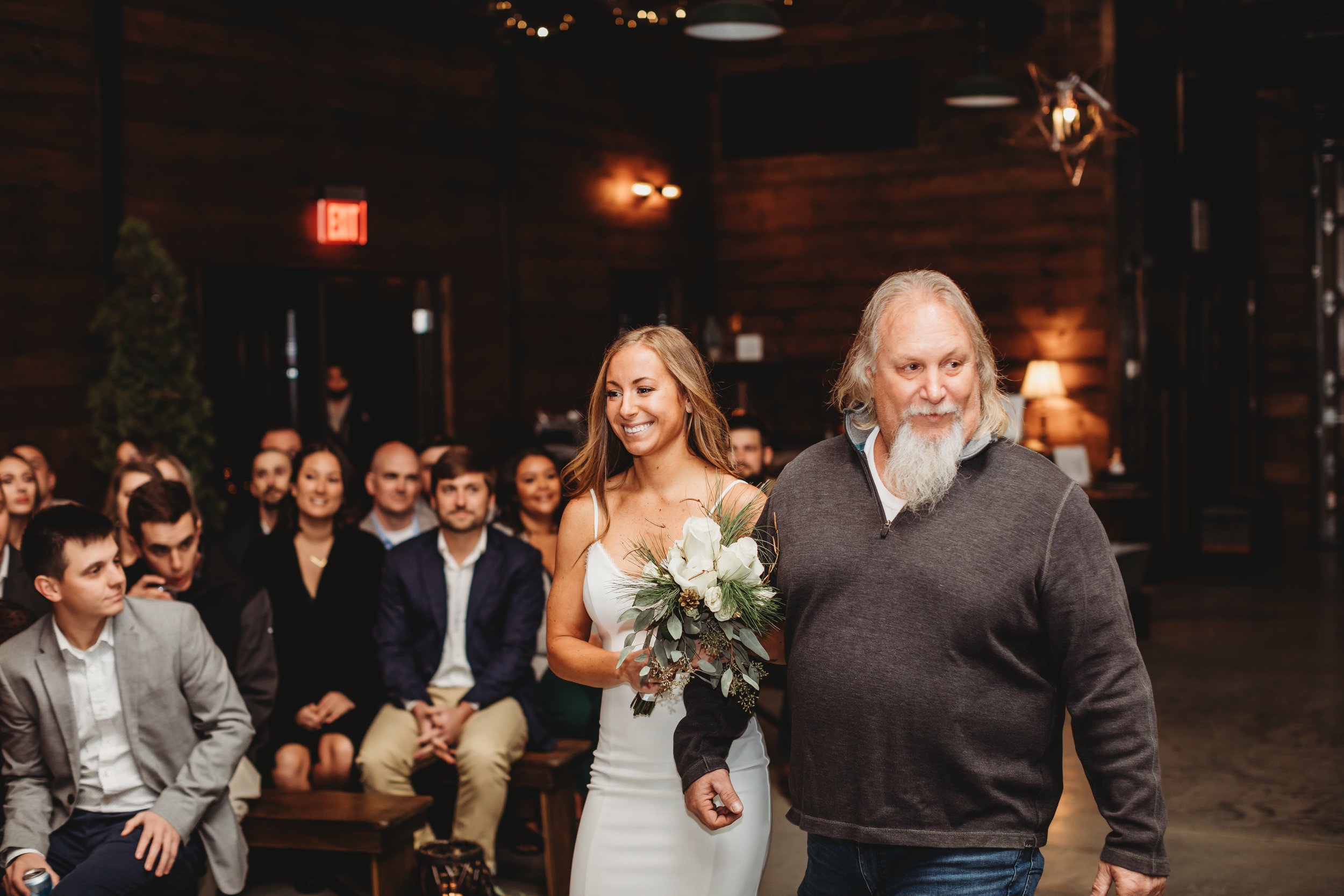  Teala Ward Photography captures a bride walking down the aisle with her in a cabin in LaSalle, IL. cabin wedding simple wedding gown #tealawardphotography #tealawardweddings #LaSalleIllinois #IronwoodontheVermillion #weddingphotographyIL 