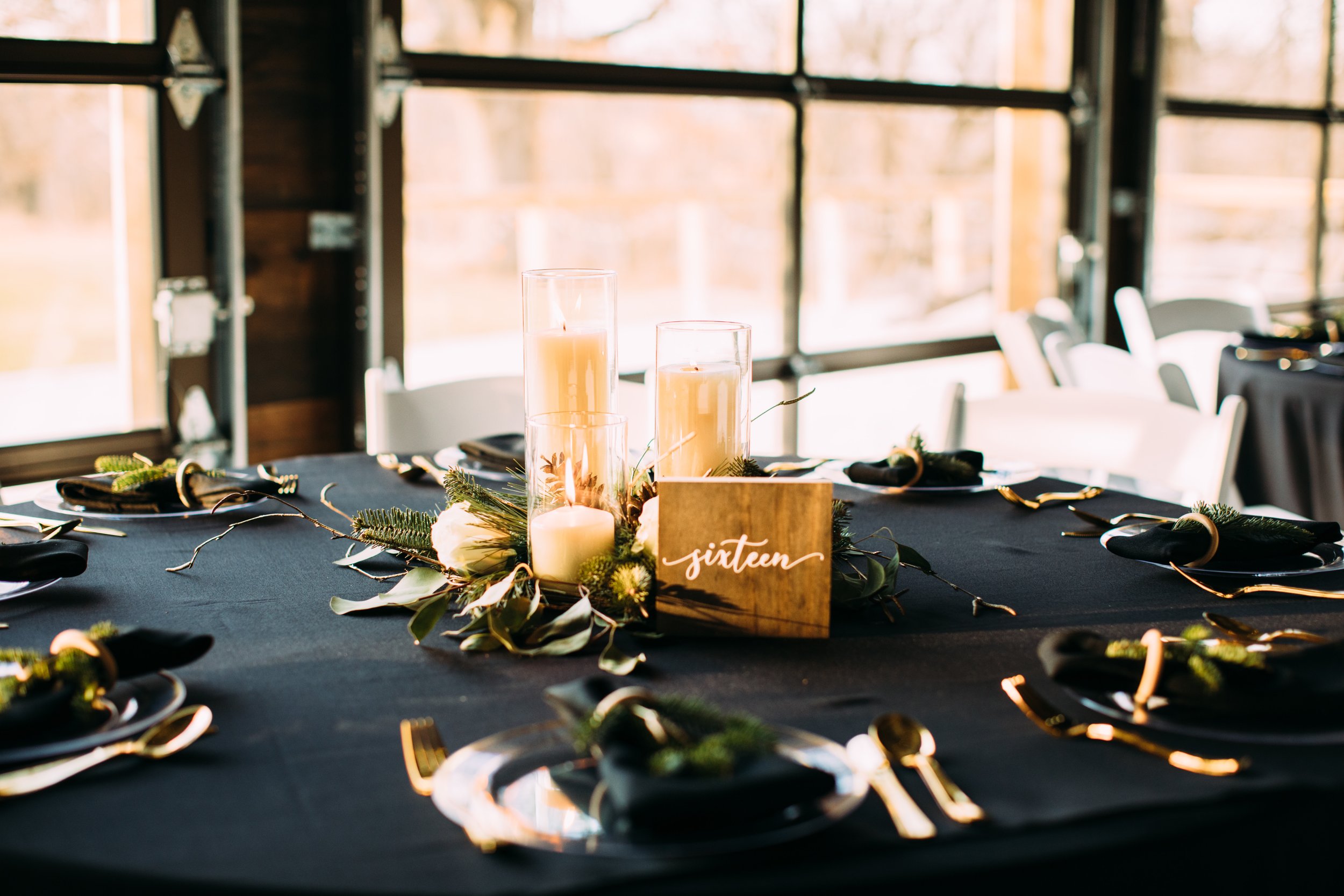  Elegant wedding tables with green fir white rose fresh florals and candles and black tablecloths by Teala Ward Photography. fir centerpiece #tealawardphotography #tealawardweddings #LaSalleIllinois #IronwoodontheVermillion #weddingphotographyIL 