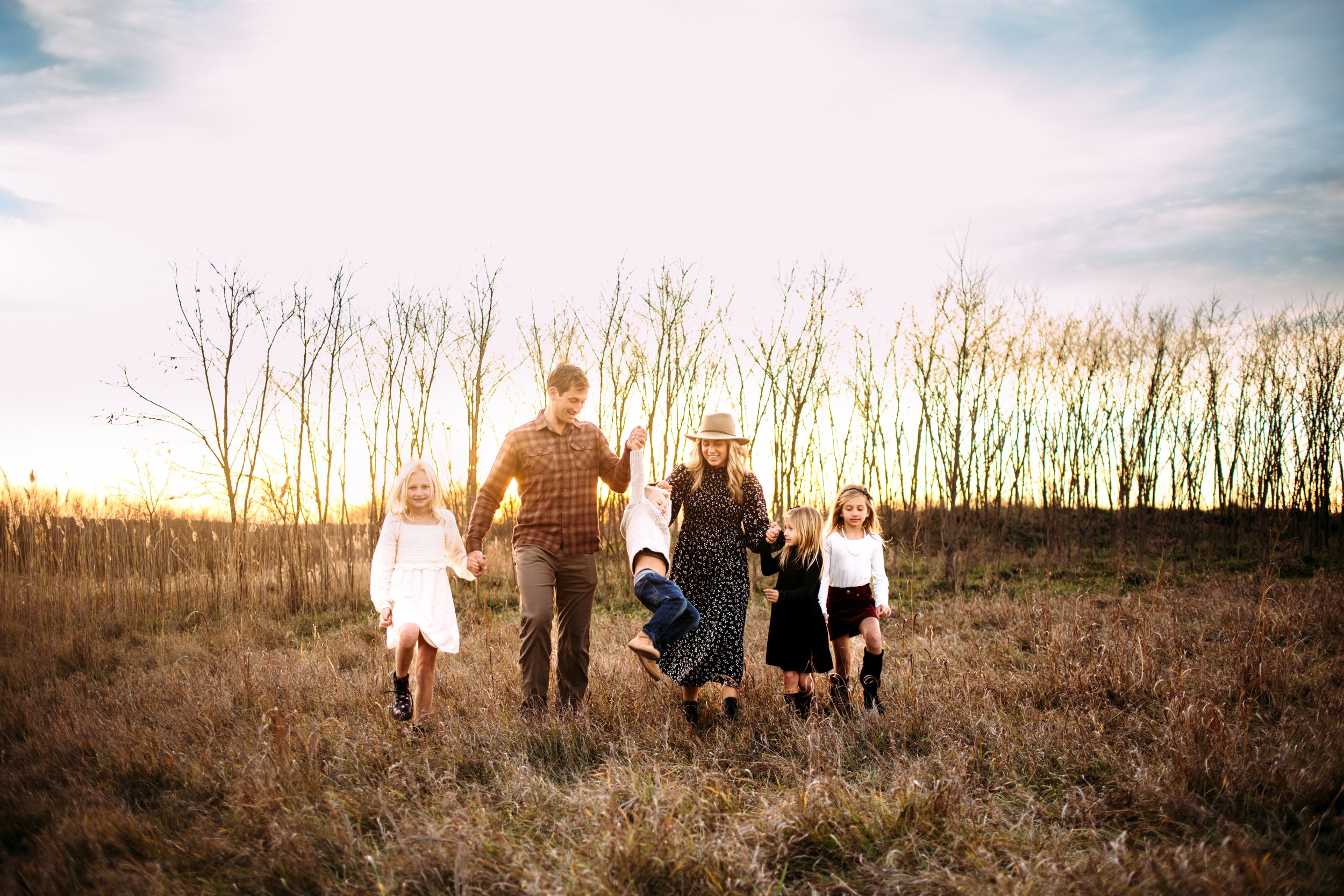  Teala Ward Photography captures a family walking through a yellow grass field at Buffalo Rock while holding hands. holding hands #TealaWardPhotography #TealaWardFamilies #StarvedRockStatePark #BuffaloRockPhotographer #UticaIllinoisphotographer 