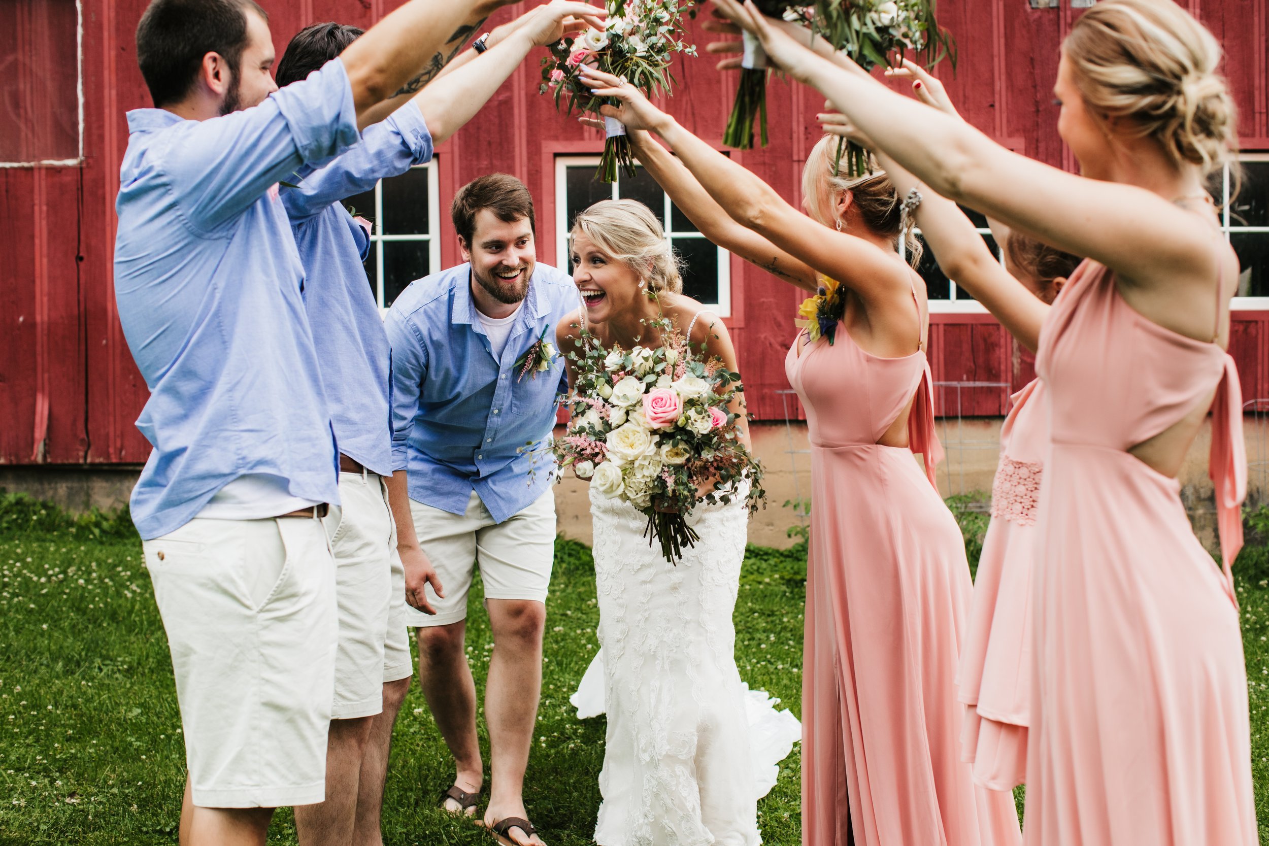  Wedding party in front of a red barn after a casual intimate wedding. groom wore shorts and flip flops bride wore lace dress roses pink bridesmaid dresses #TealaWardPhotography #illinoisphotographer #princetonillinois #weddingphotographer #intimatew