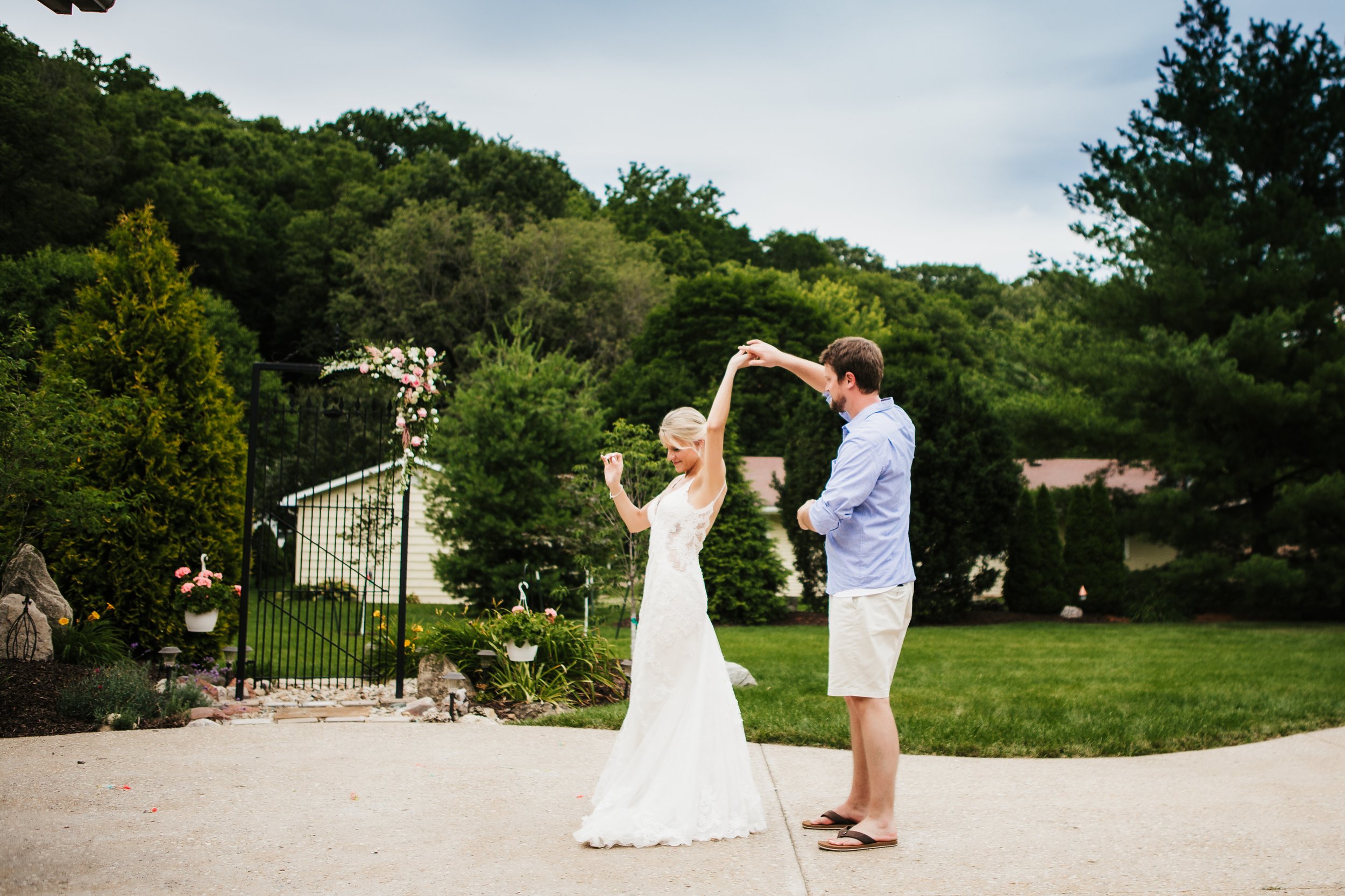  Husband and wife have their first dance after their intimate wedding ceremony in front of a barn. dance white wedding dress lace groom in shorts #TealaWardPhotography #illinoisphotographer #princetonillinois #weddingphotographer #intimatewedding 