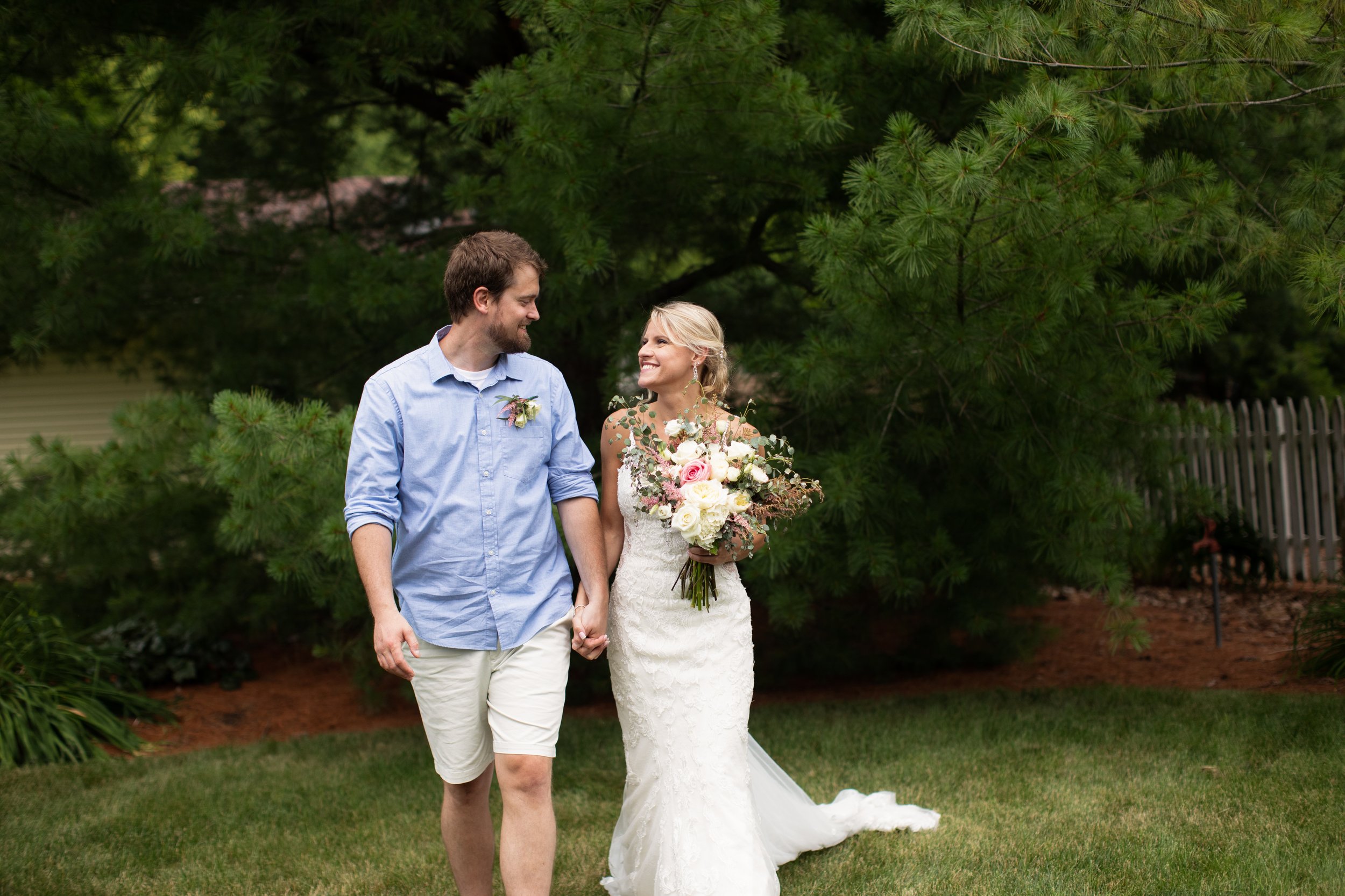  Husband and wife smile at each other after their intimate wedding ceremony. wedding in a backyard barn lace dress casual wedding #TealaWardPhotography #illinoisphotographer #princetonillinois #weddingphotographer #intimatewedding 