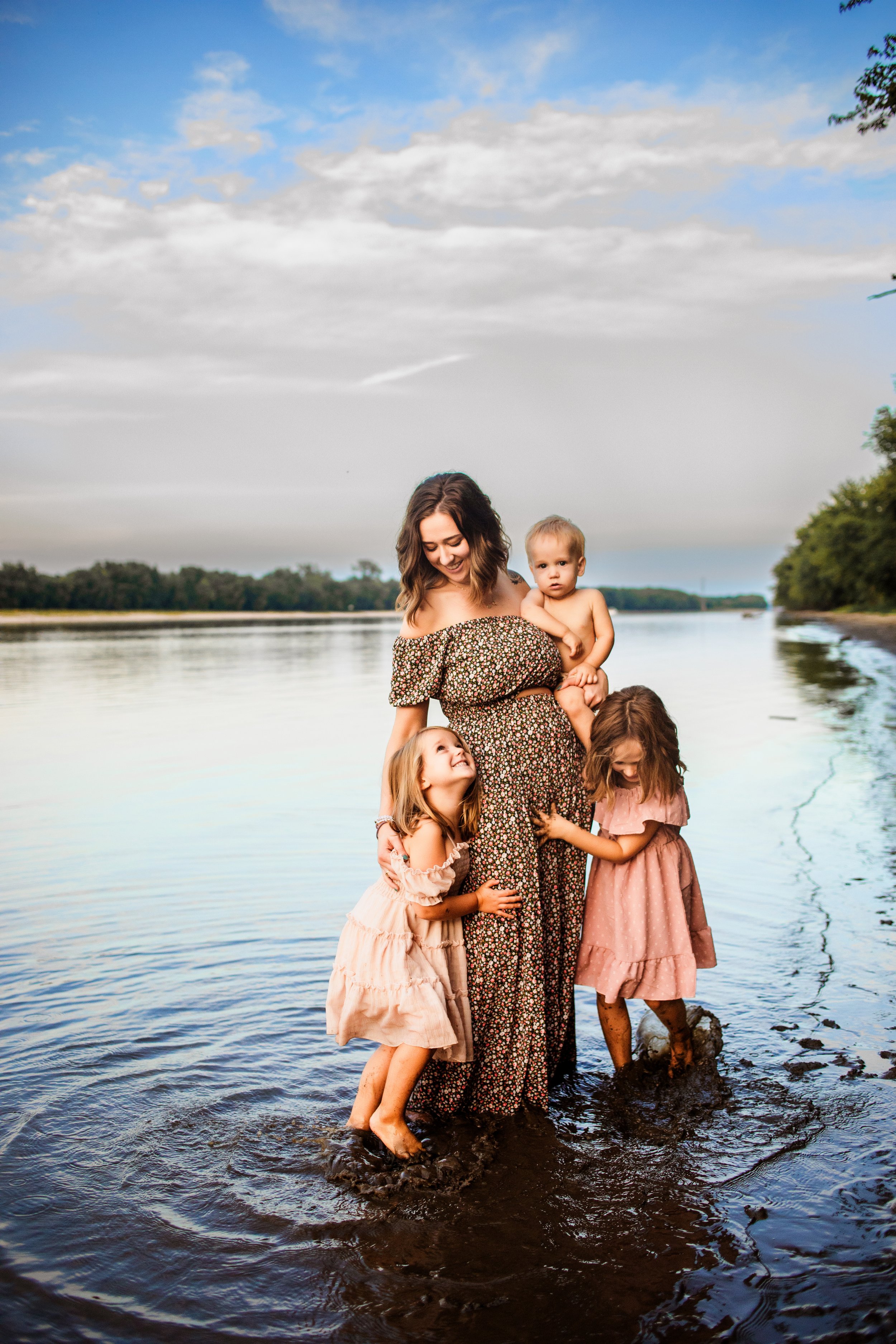  Standing in a river a mother loves on her three young children by Teala Ward Photography in Illinois. Illinois River Photography #TealaWardPhotography #TealaWardFamilies #IllinoisRiverPhotography #IllinoisFamilyPhotography #familylifestylepics 