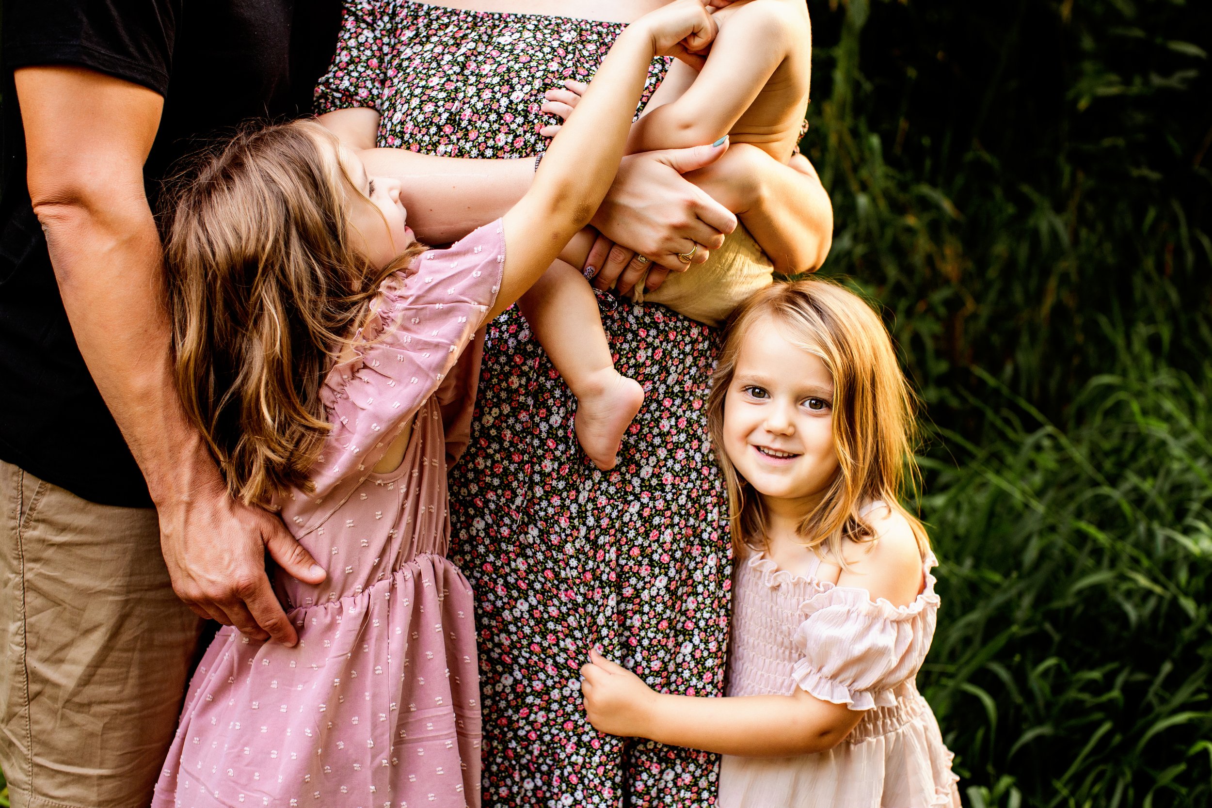  A young girl wearing a pink dress hugs her mother during a photography session with Teala Ward Photography in Illinois. girl style #TealaWardPhotography #TealaWardFamilies #IllinoisRiverPhotography #IllinoisFamilyPhotography #familylifestylepics 