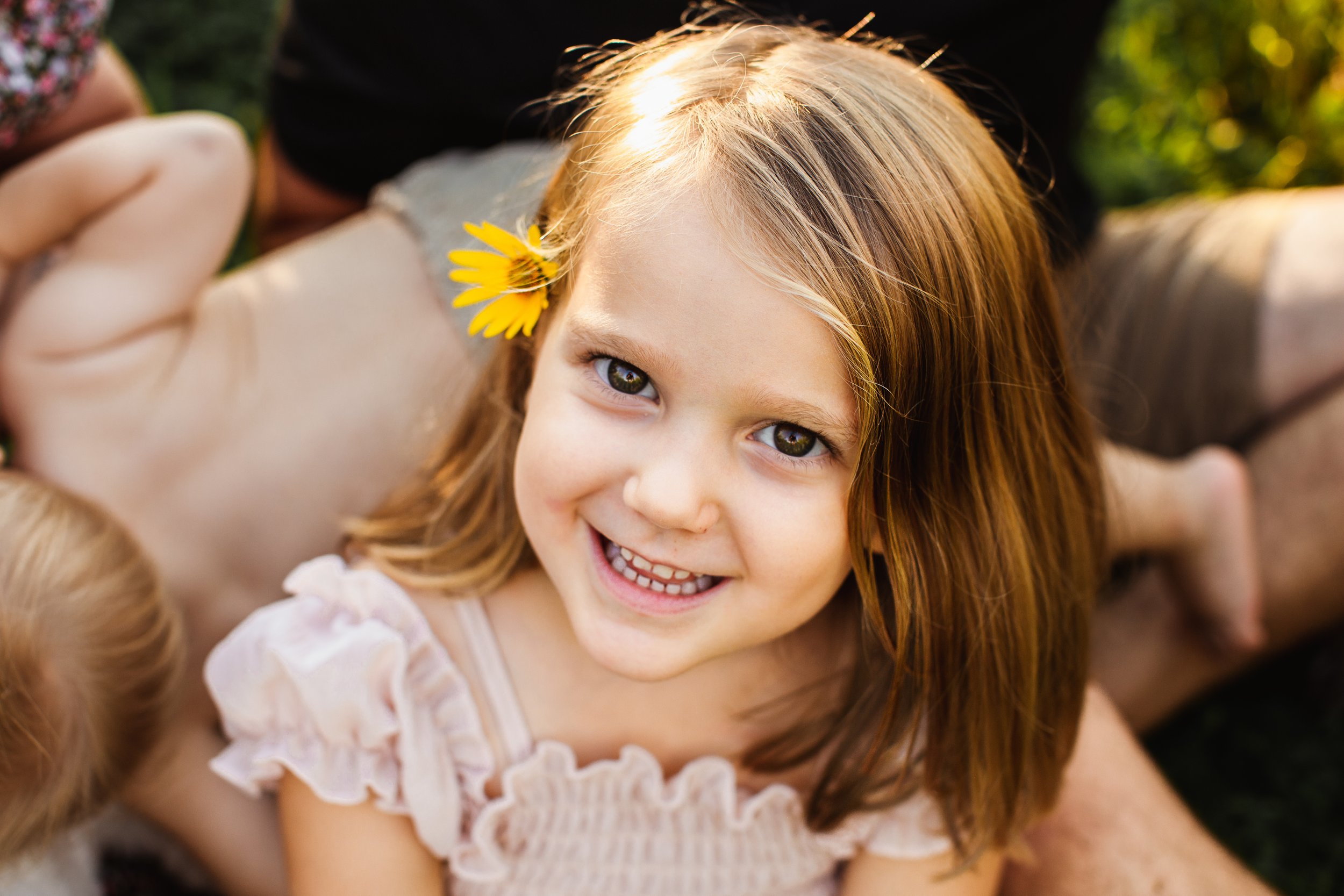  Teala Ward Photography captures a portrait of a toddler girl with a yellow flower tucked behind her ear. Little girl portraits #TealaWardPhotography #TealaWardFamilies #IllinoisRiverPhotography #IllinoisFamilyPhotography #familylifestylepics 