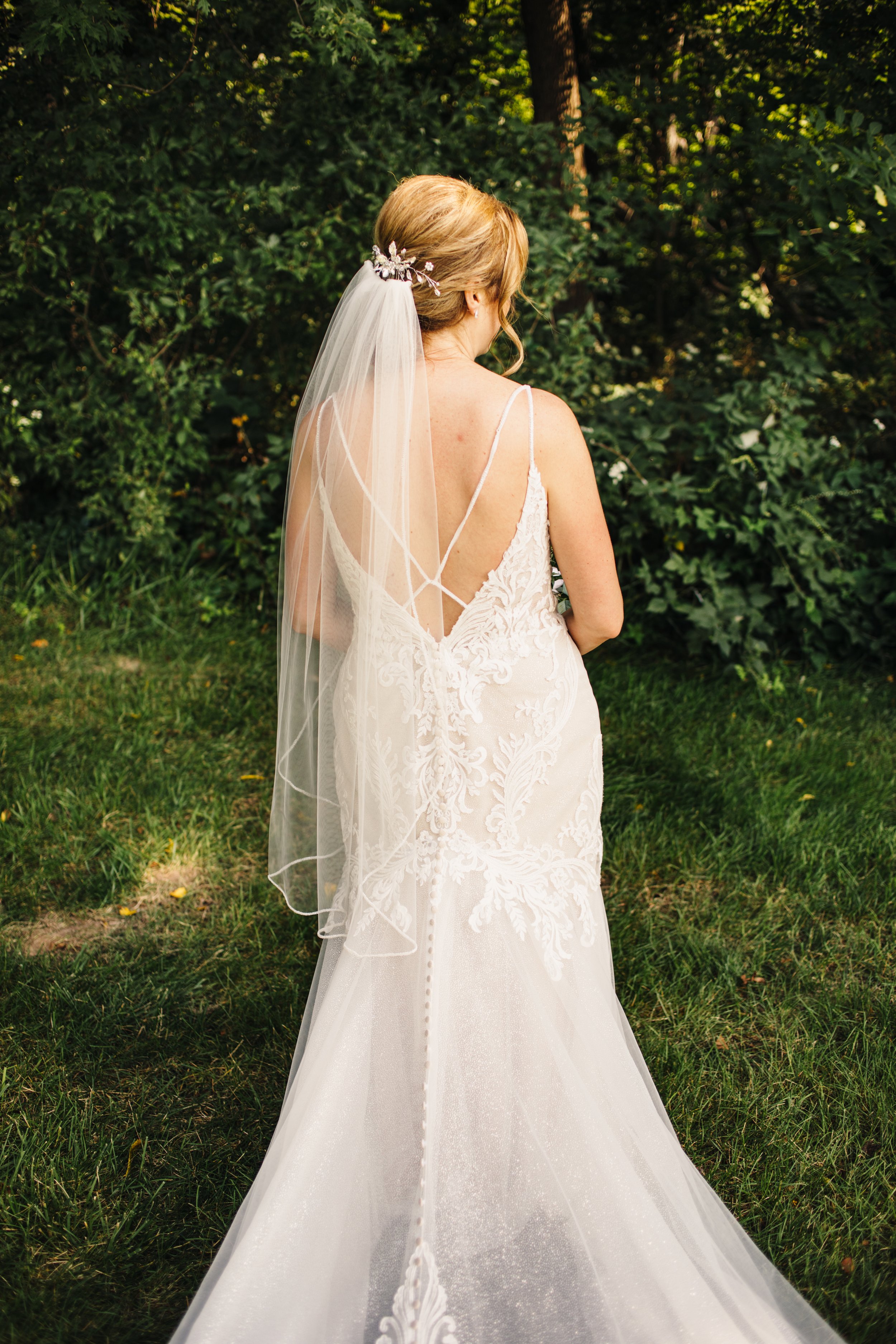  A bride with a sheer veil and strappy back with buttons all the way down by Teala Ward Photography. button down dress wedding dress summer #TealaWardPhotography #IllinoisValleyPhotographer #summerwedding #TealaWardWeddings #Illinoisweddings  