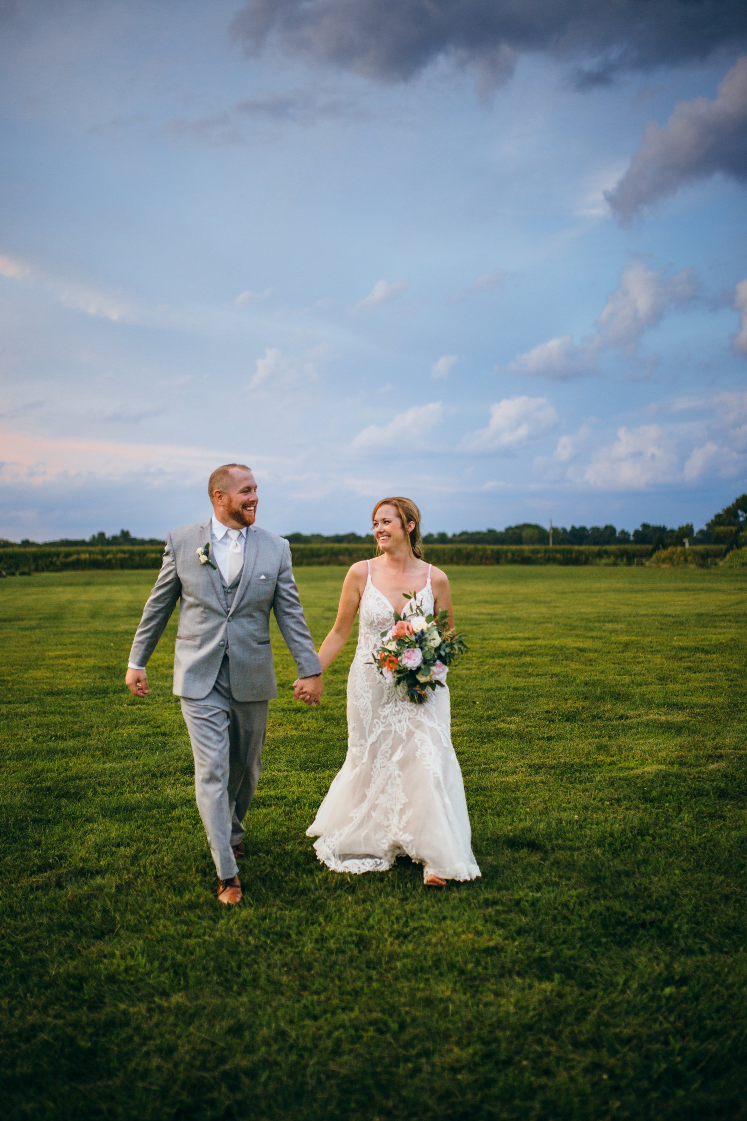  In the Illinois Valley, a bride and groom hold hands and look into each other's eyes by Teala Ward Photography. dramatic wedding portraits #TealaWardPhotography #IllinoisValleyPhotographer #summerwedding #TealaWardWeddings #Illinoisweddings  