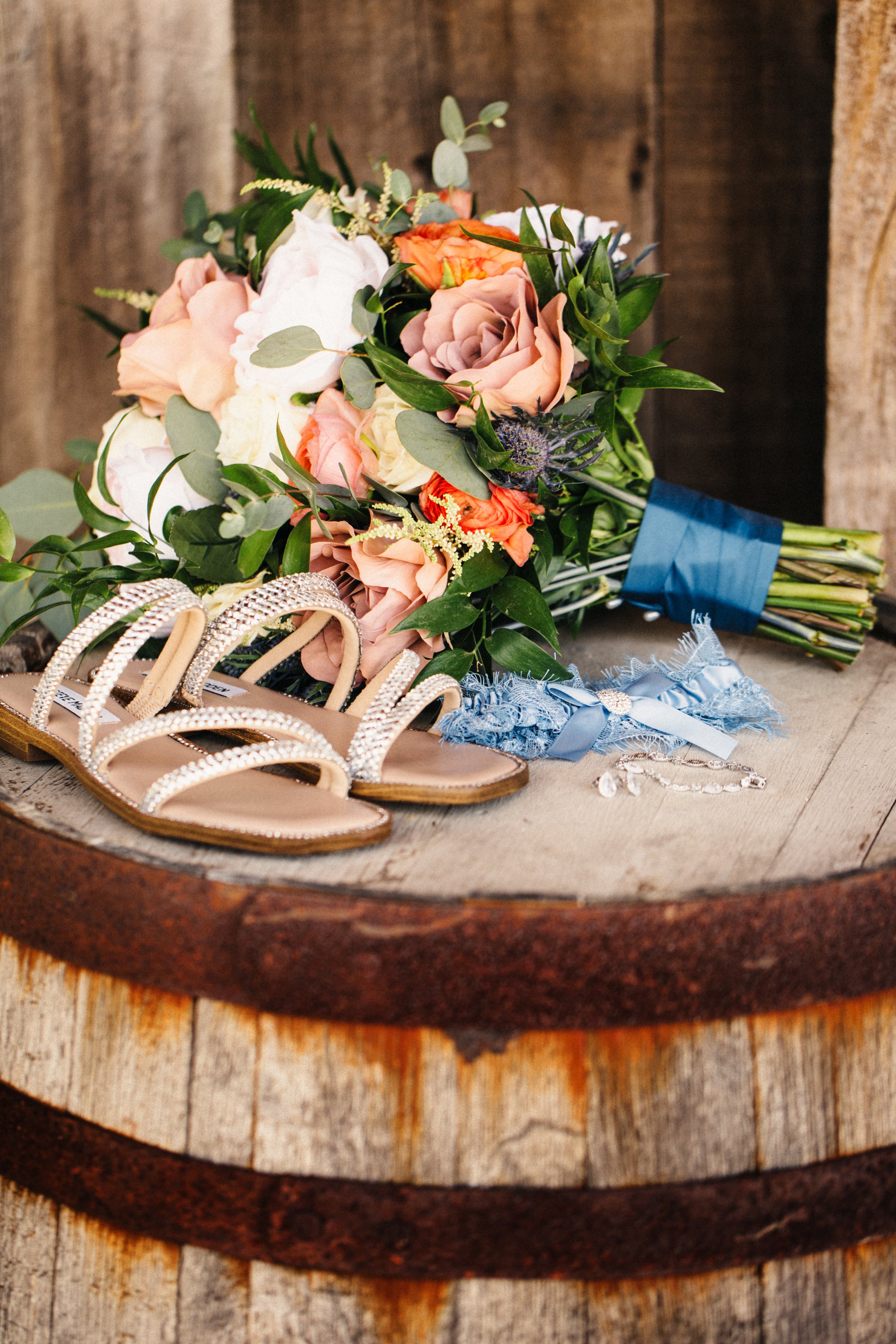  Southern wedding with a wooden barrel with the bride's shoes and bridal bouquet by Teala Ward Photography. Southern Belle Wedding Country #TealaWardPhotography #IllinoisValleyPhotographer #summerwedding #TealaWardWeddings #Illinoisweddings  