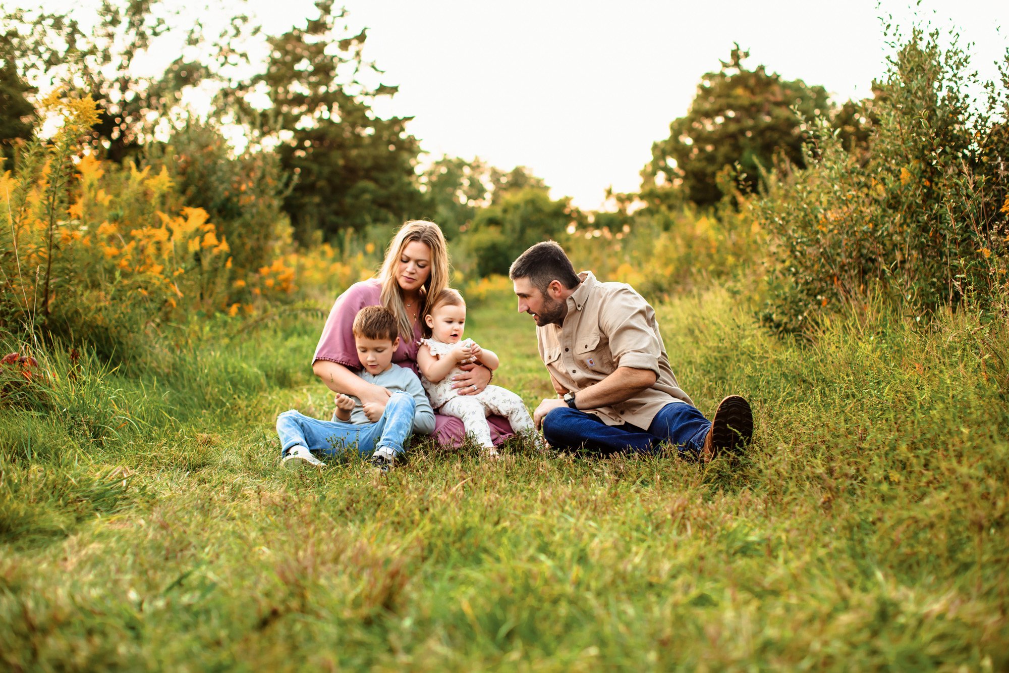  A full family session in Illinois with Teala Ward Photography sitting in the grass pathway. family moment photography #TealaWardPhotography #TealaWardFamilies #minisessionvsfullsessions #photography #Illinoisphotography #familyminisession 