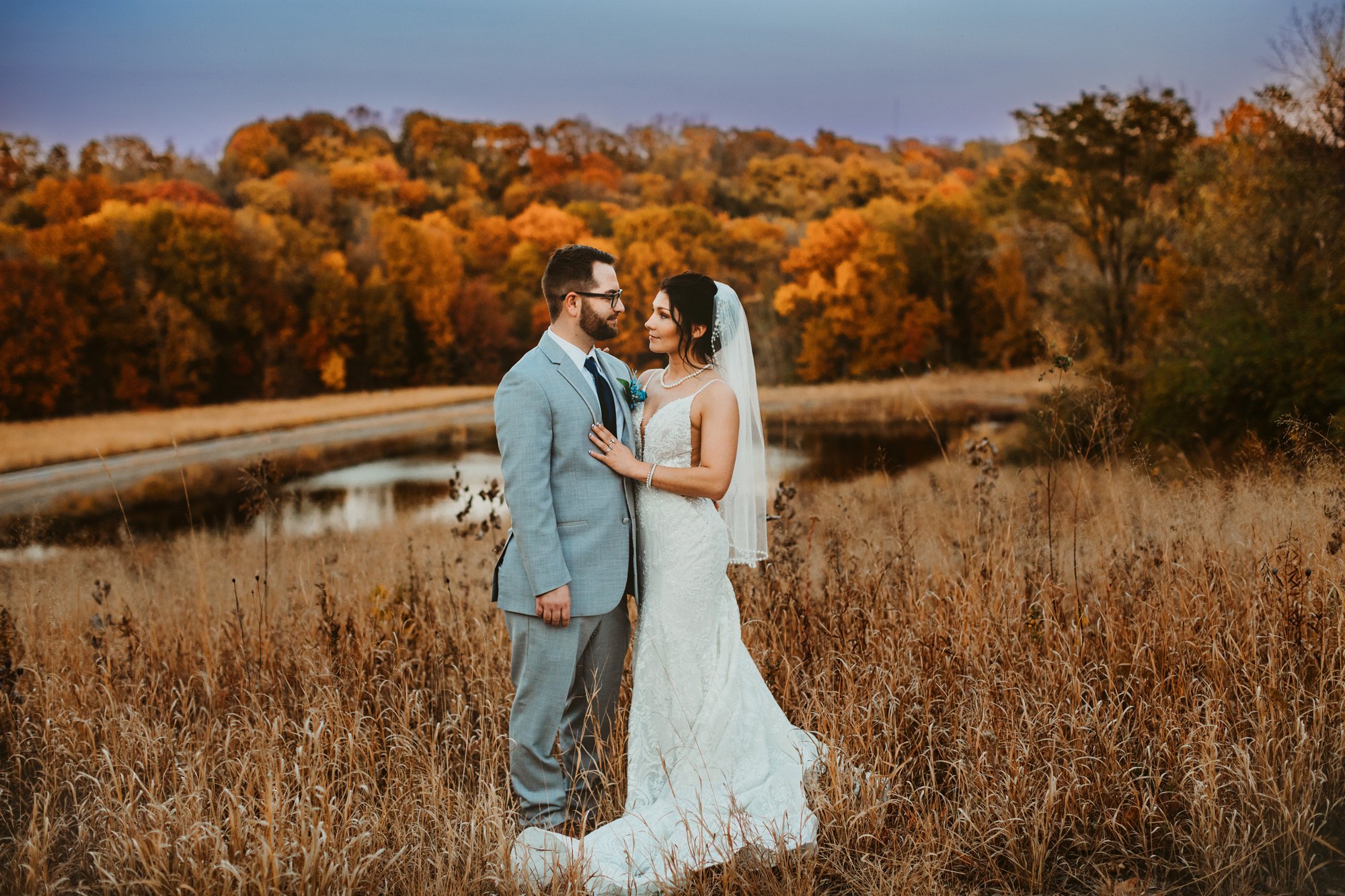  With a pond, yellow grass, and fall trees a bride and groom fall in love with Teala Ward Photography. season weddings #TealaWardPhotography #TealaWardWeddings #WeddingLocationsIllinois #IllinoisWedding #weddingdetails #weddingphotography #married 