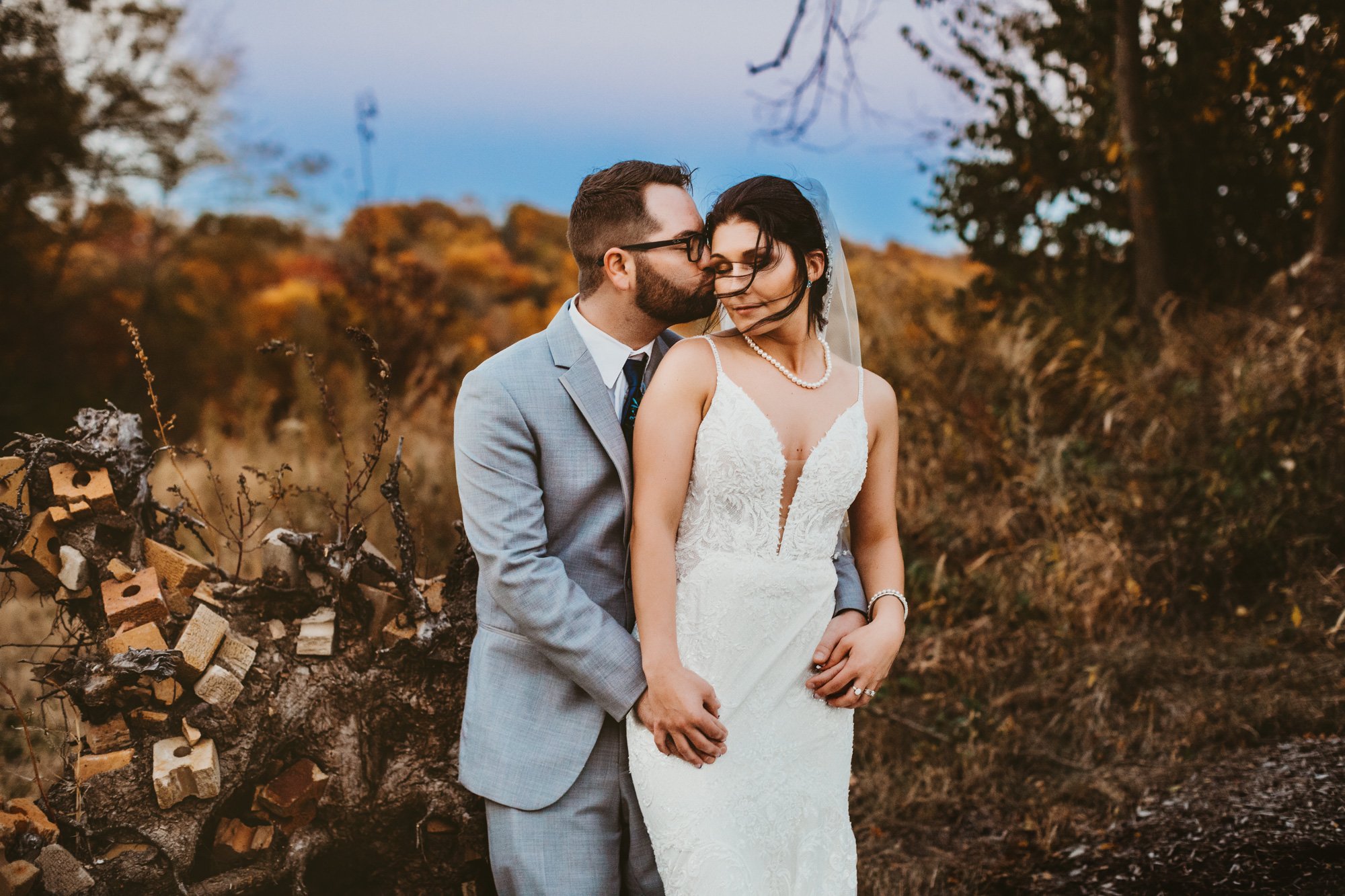  The groom kisses the bride’s cheek in an October landscape by Teala Ward Photography. Illinois fall weddings #TealaWardPhotography #TealaWardWeddings #WeddingLocationsIllinois #IllinoisWedding #weddingdetails #weddingphotography #married 