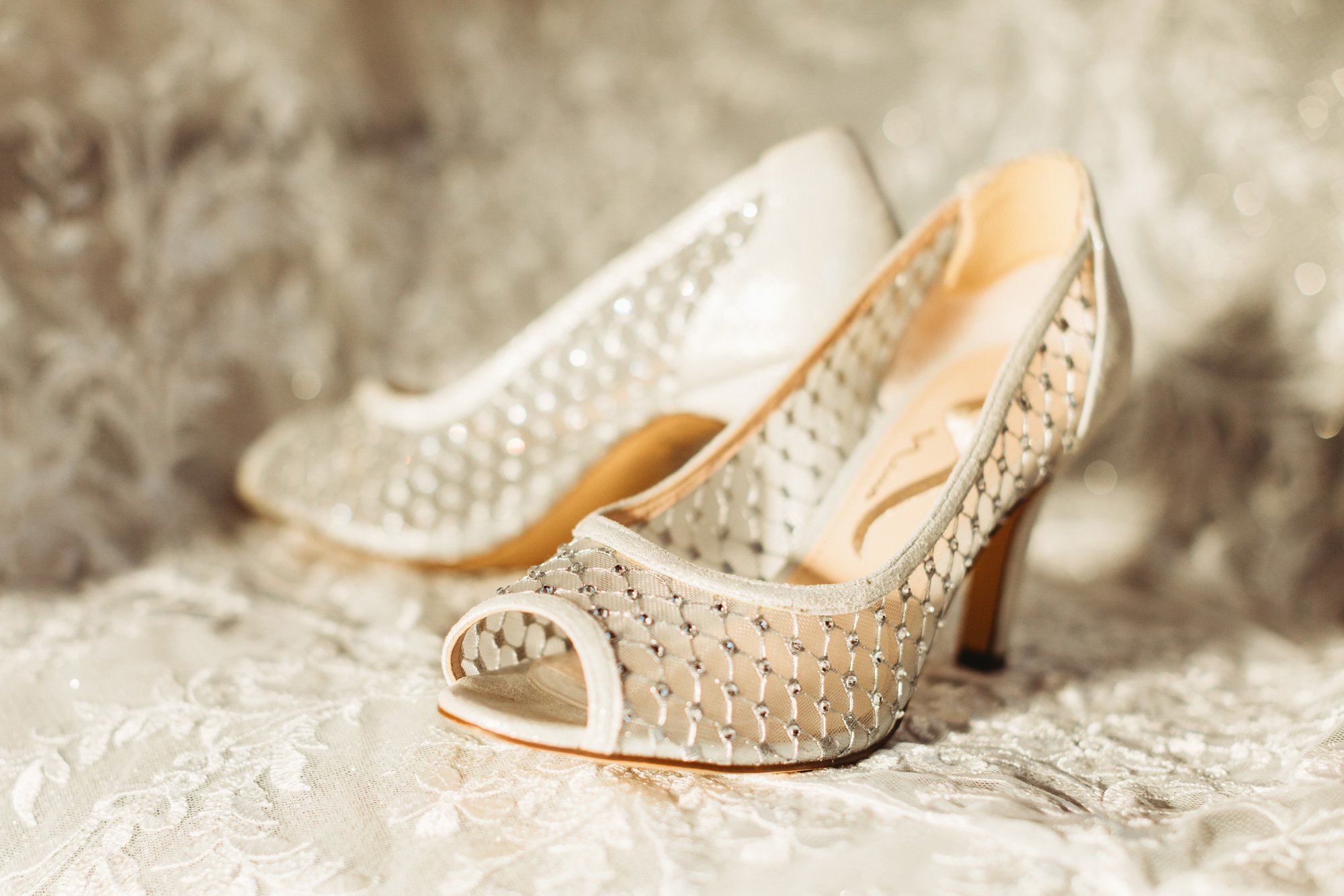  Teala Ward Photography captures details of the bridal shoes with rhinestones and peeps toes. bridal shoes elegant #TealaWardPhotography #TealaWardWeddings #WeddingLocationsIllinois #IllinoisWedding #weddingdetails #weddingphotography #married 