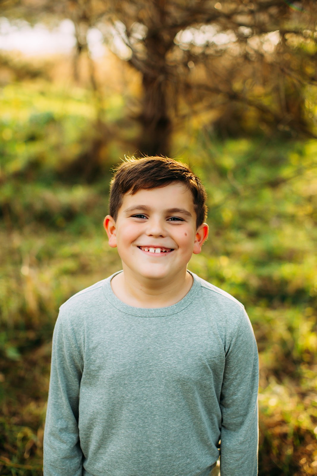  A boy wearing a long-sleeved shirt smiles for a portrait taken by Teala Ward Photography. Boy style for family photos #TealaWardPhotography #TealaWardFamilies #holidayfamilypics #photography #Illinoisfamilyphotography #familysession 