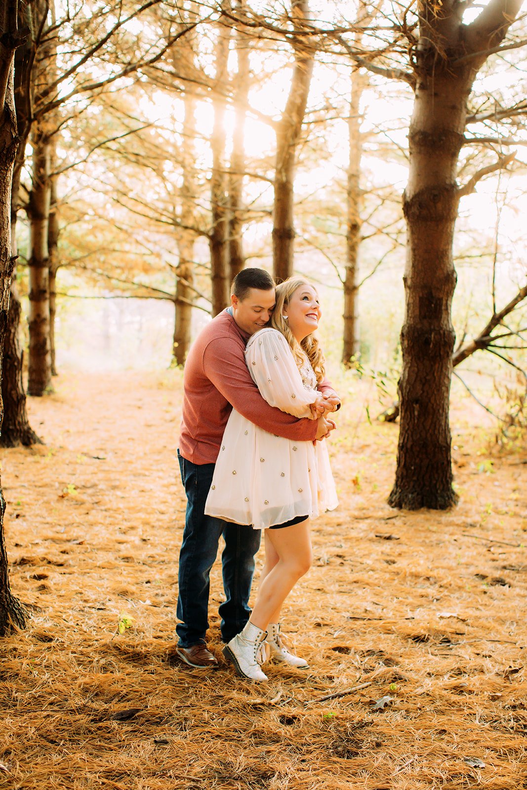  During a family photography session with Teala Ward Photography a husband and wife hug in a yellow hue forest. yellow hue pic #TealaWardPhotography #TealaWardFamilies #holidayfamilypics #photography #Illinoisfamilyphotography #familysession 